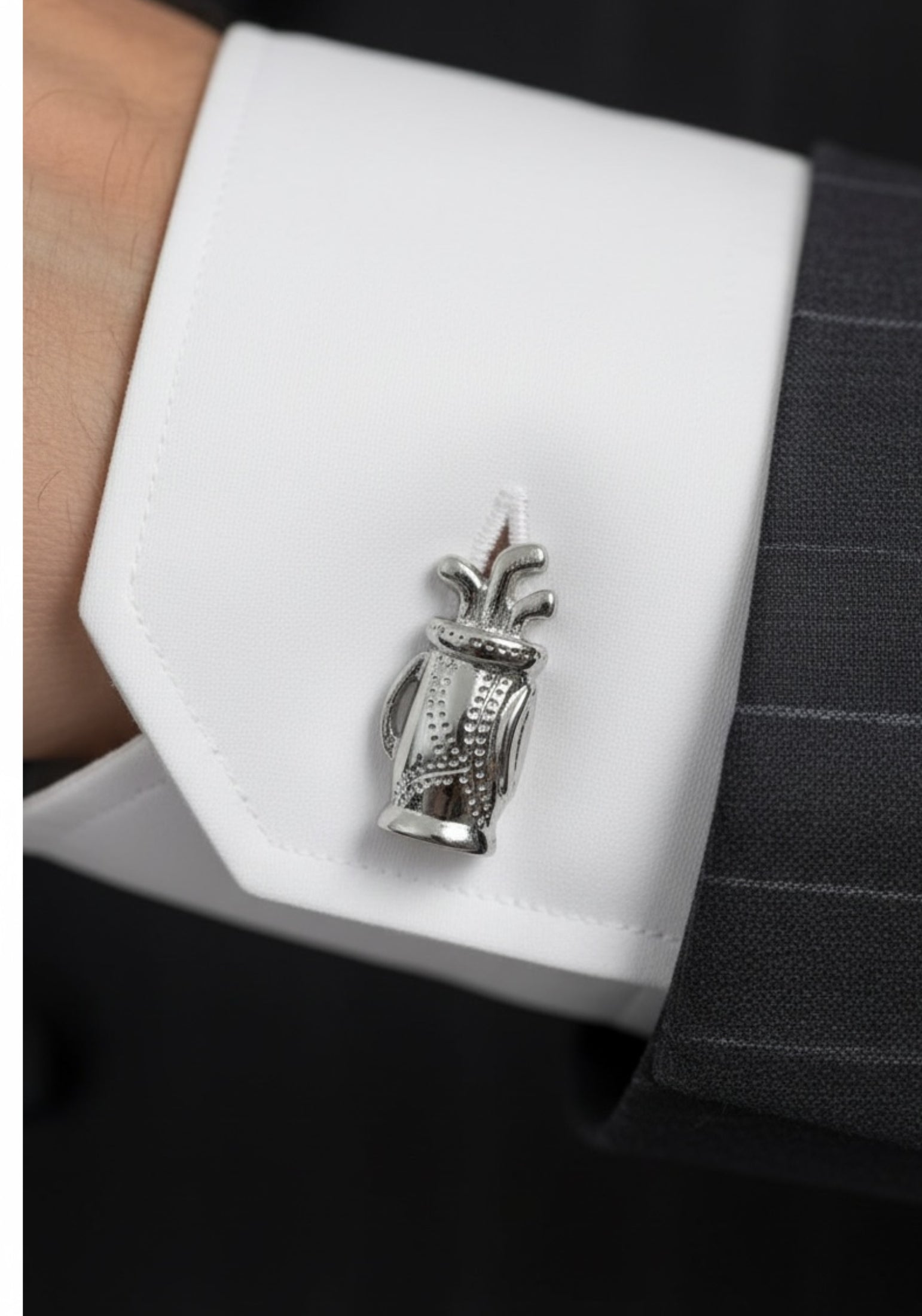 Close-up of the cufflink on a model wearing a suit.