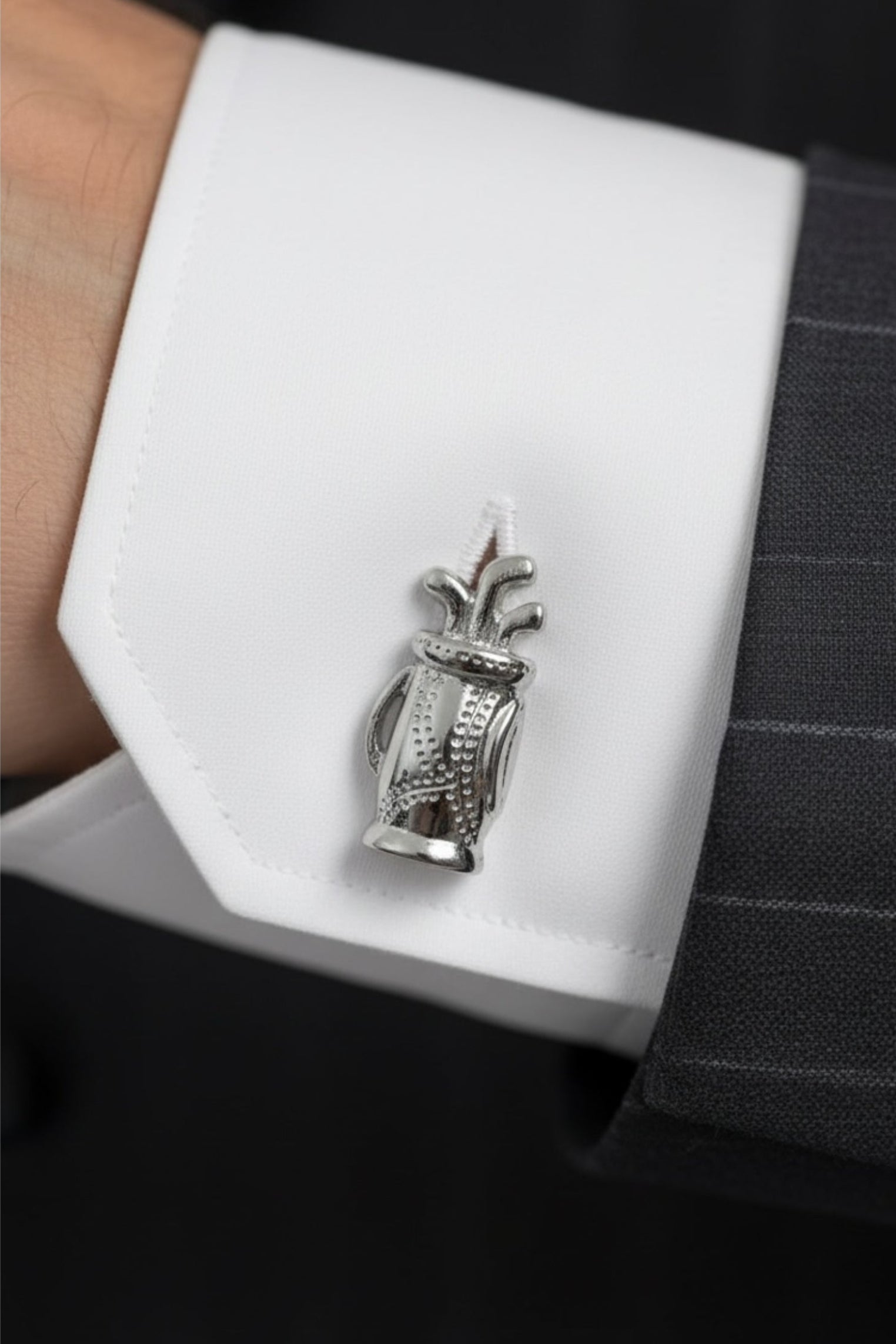 Close-up of the cufflink on a model wearing a suit.