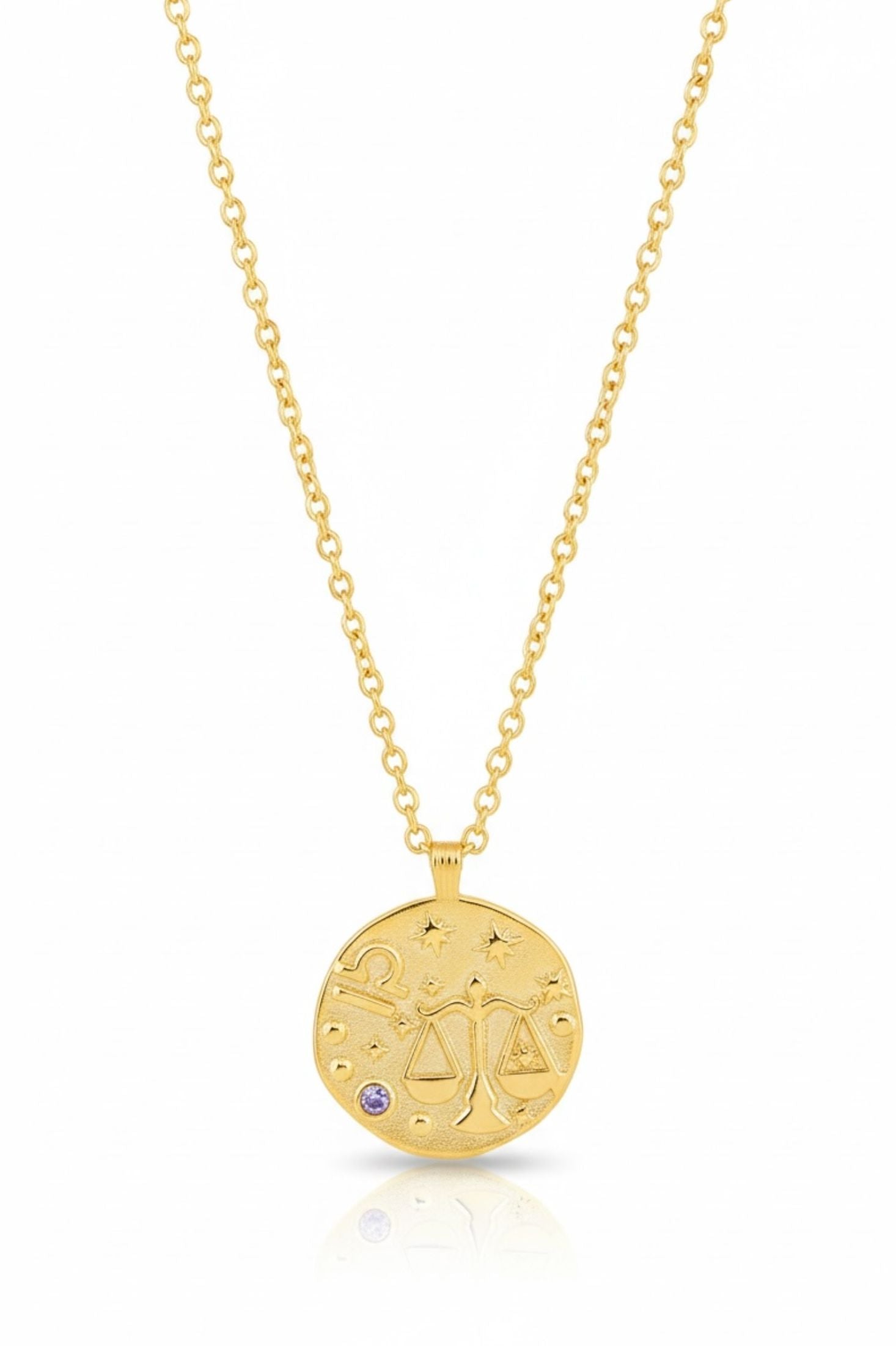 Gold necklace with Libra zodiac pendant on a white background