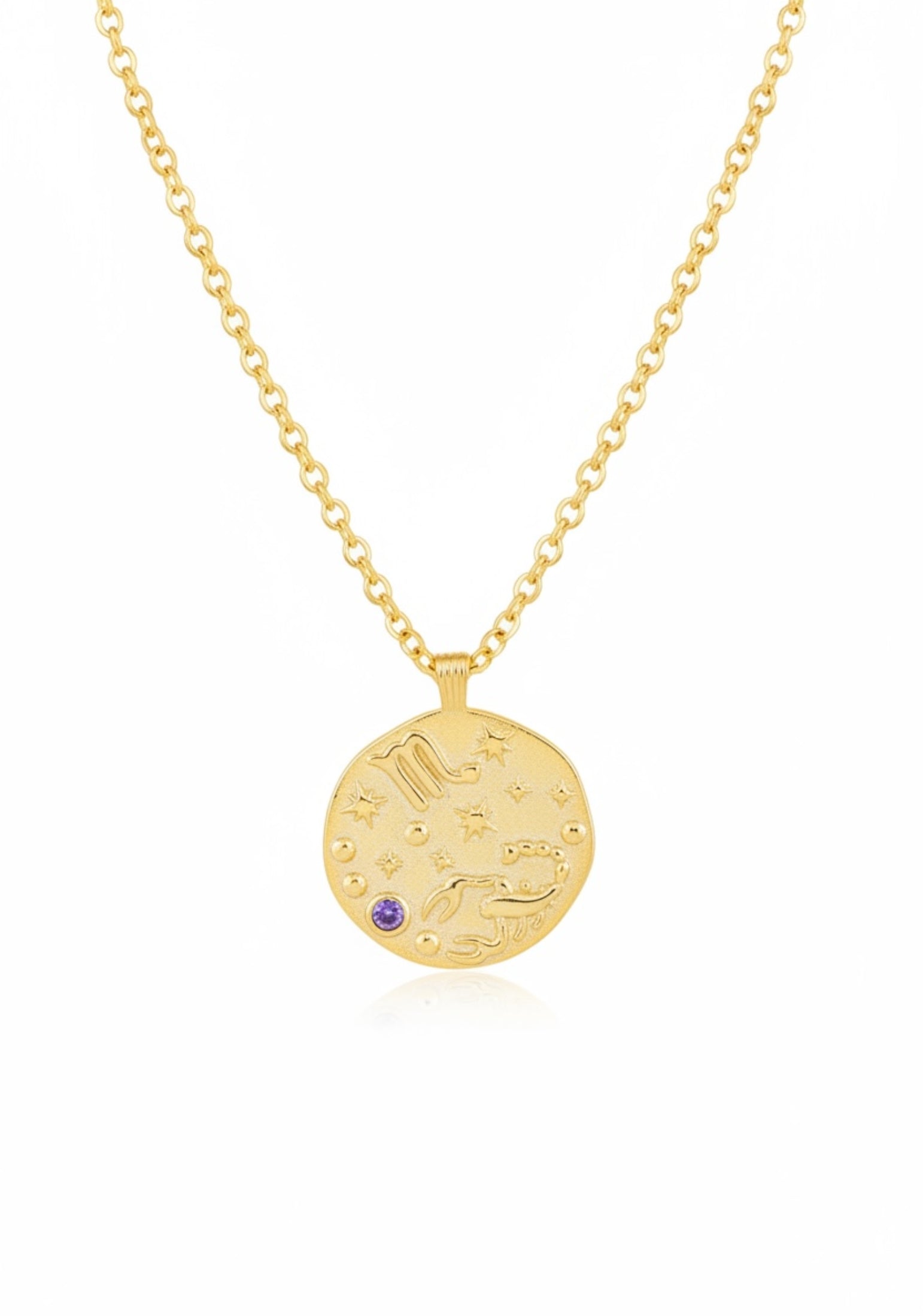 Gold necklace with a round pendant featuring celestial designs on a white background