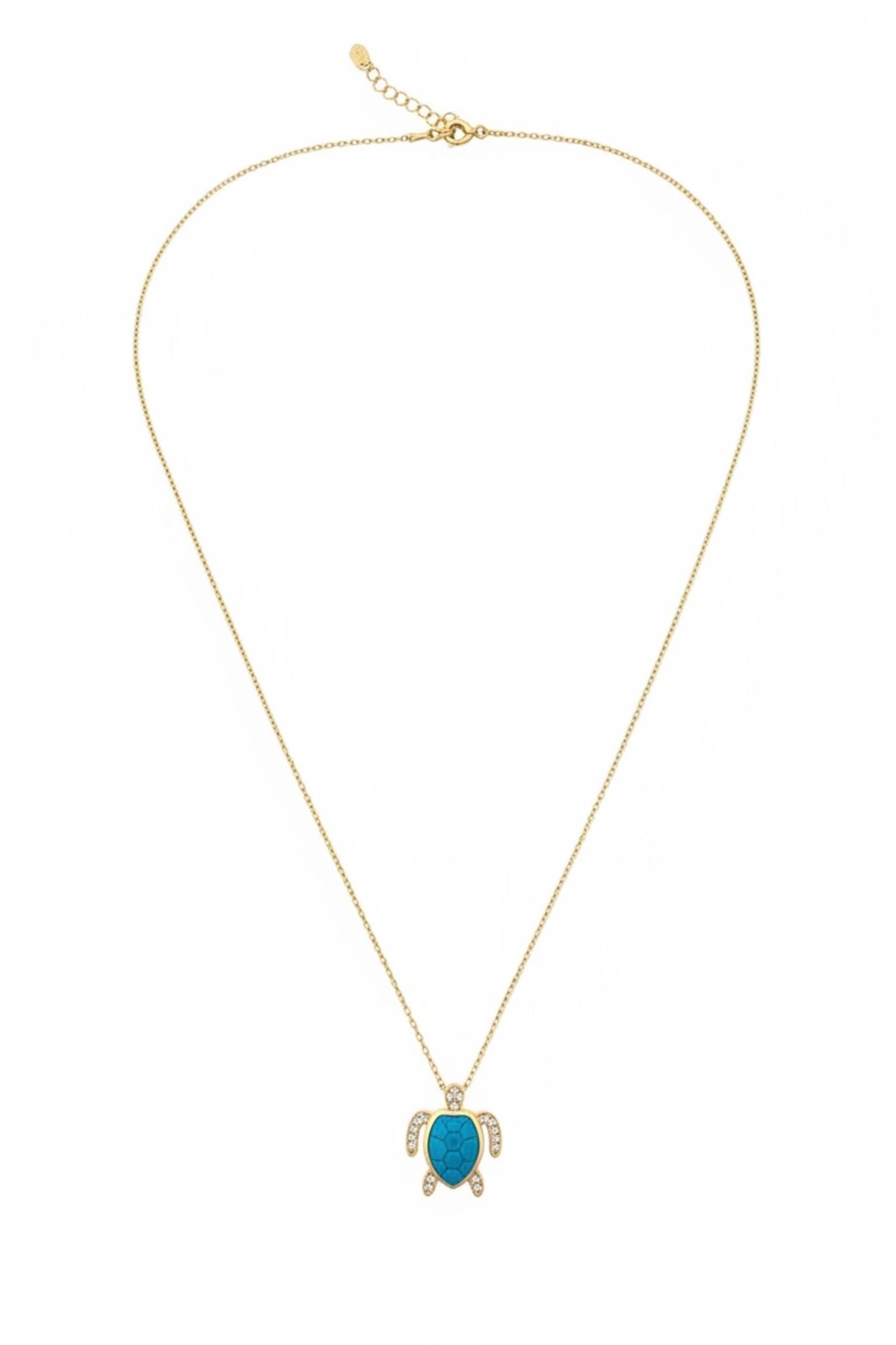 Gold necklace with a turquoise turtle pendant on a white background