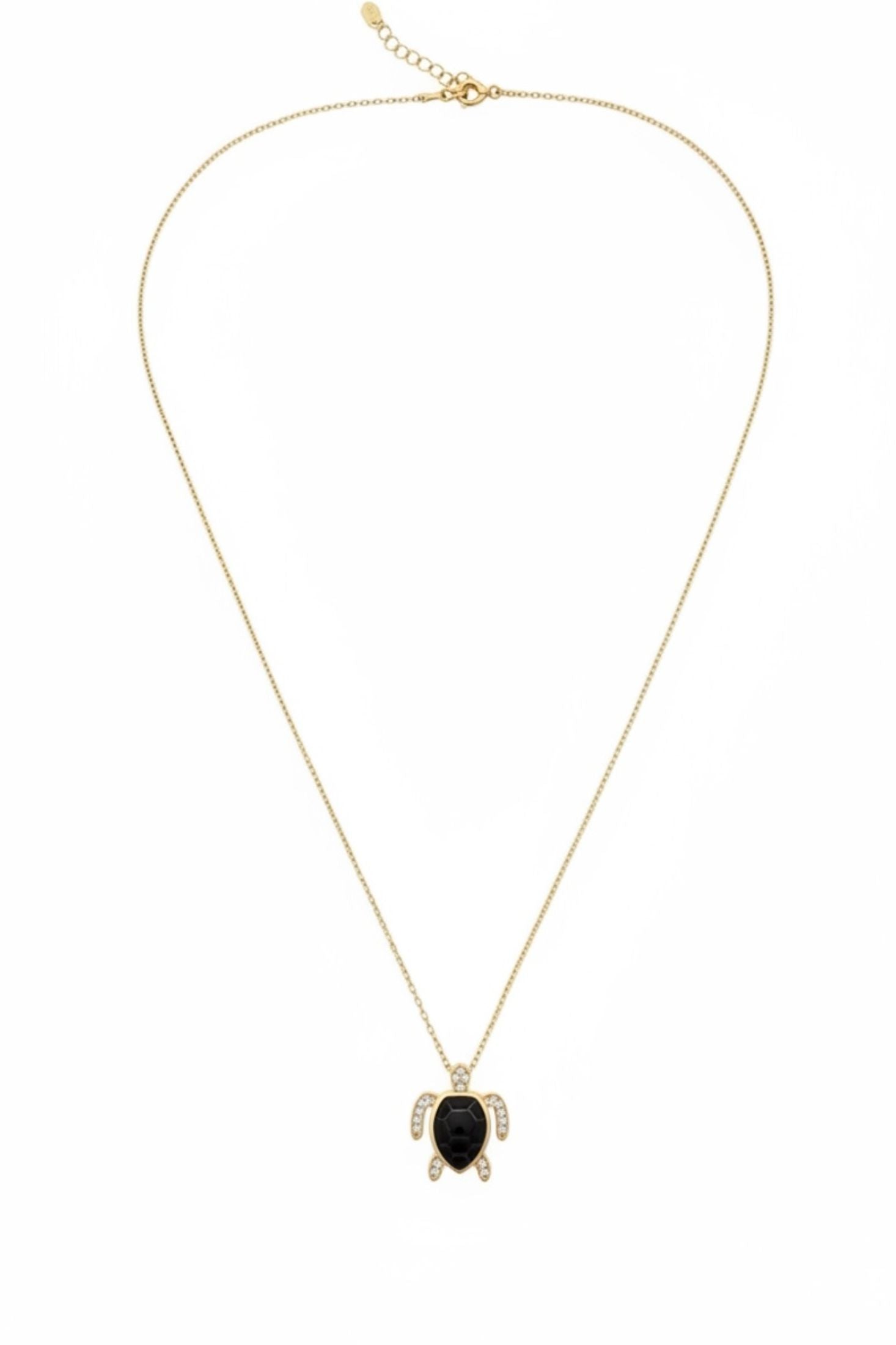Gold and black turtle pendant necklace on a white background