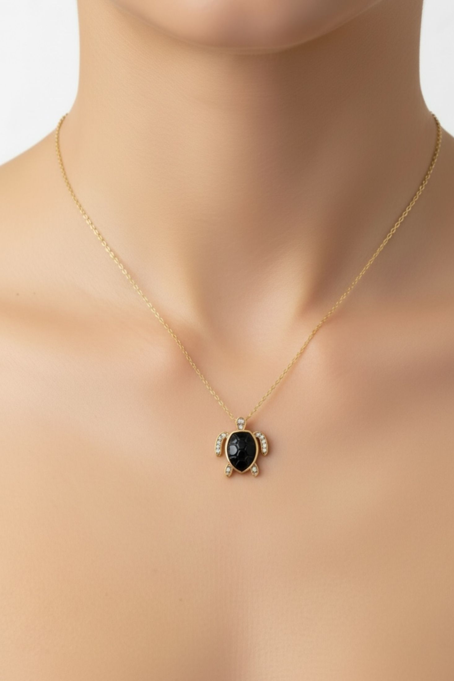 Necklace with a turtle pendant on a woman