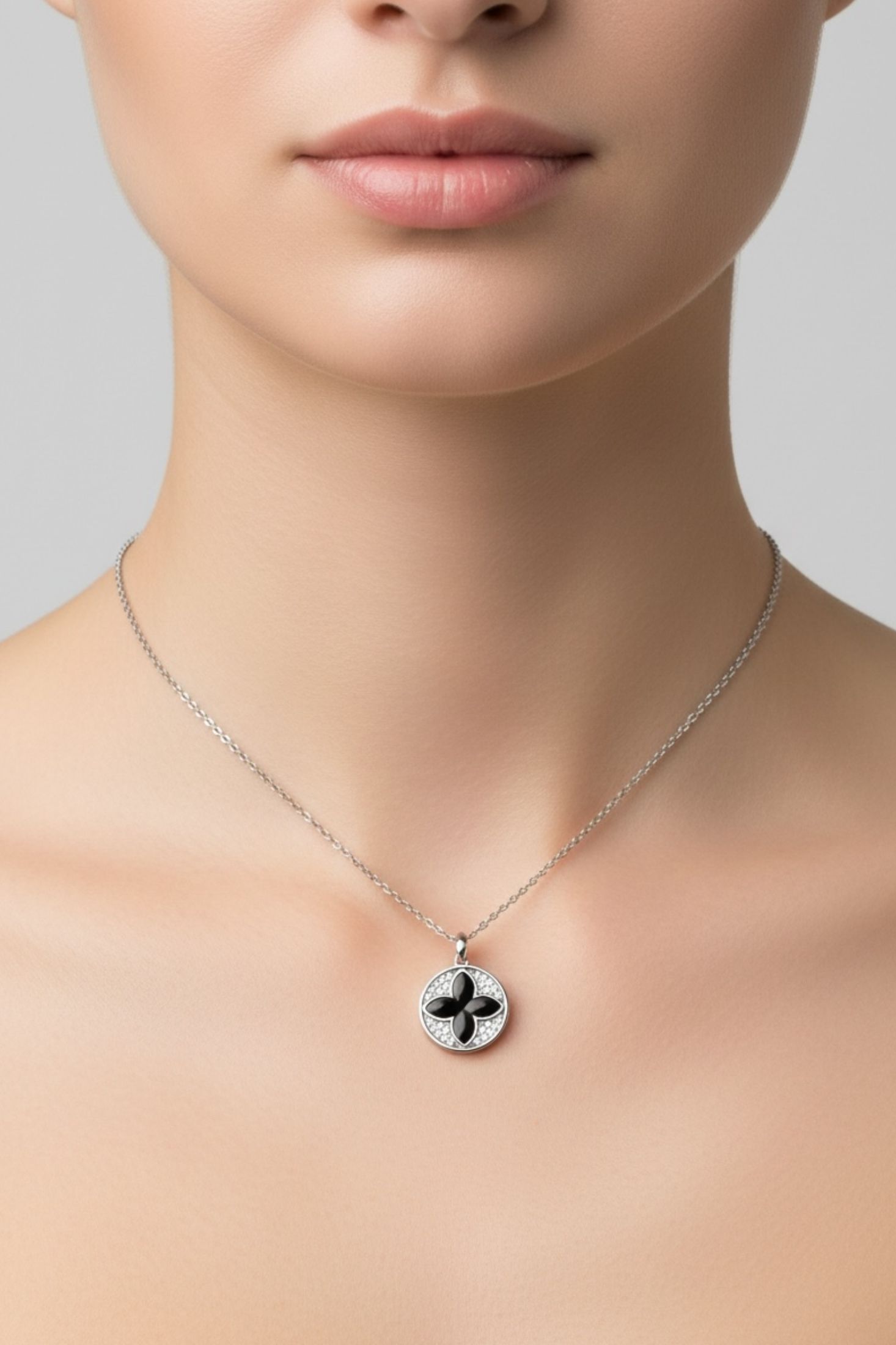 Necklace with a pendant worn by a person on a neutral background