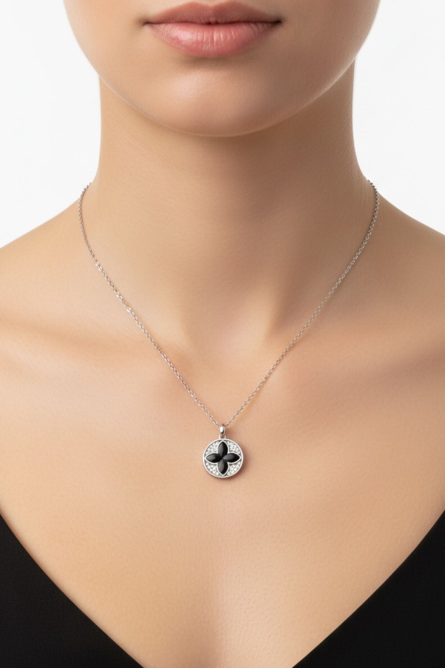 Necklace with a clover pendant on a model against a neutral background
