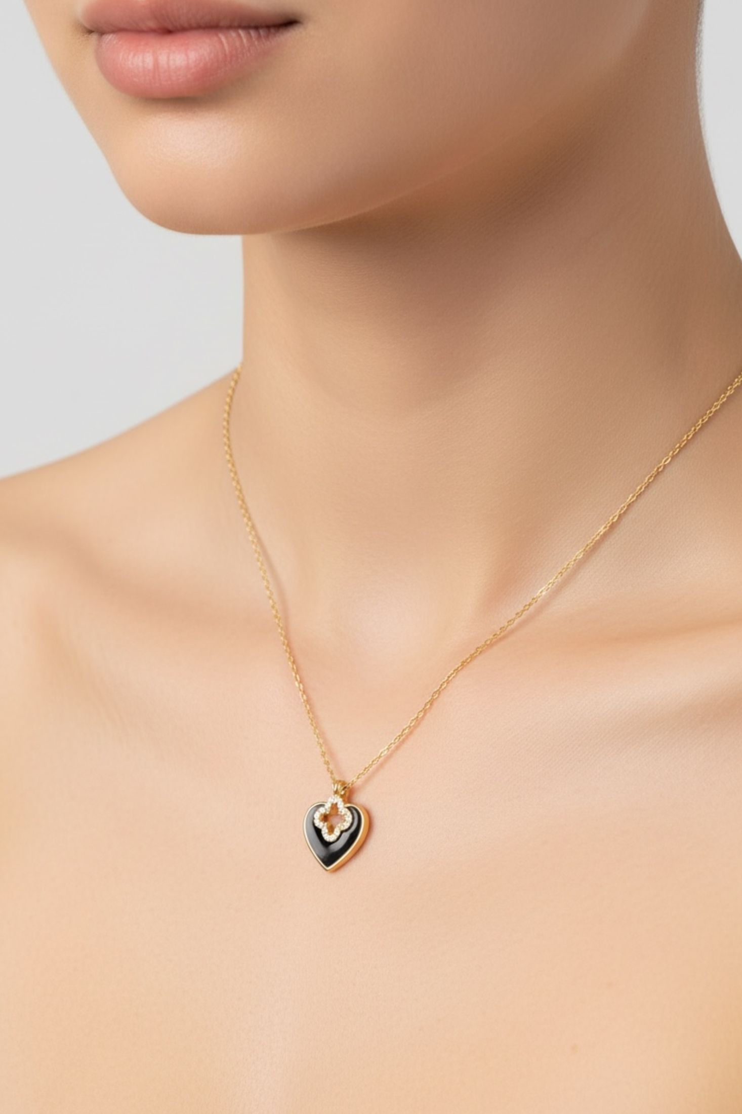 Necklace with a black heart-shaped pendant on a neutral background