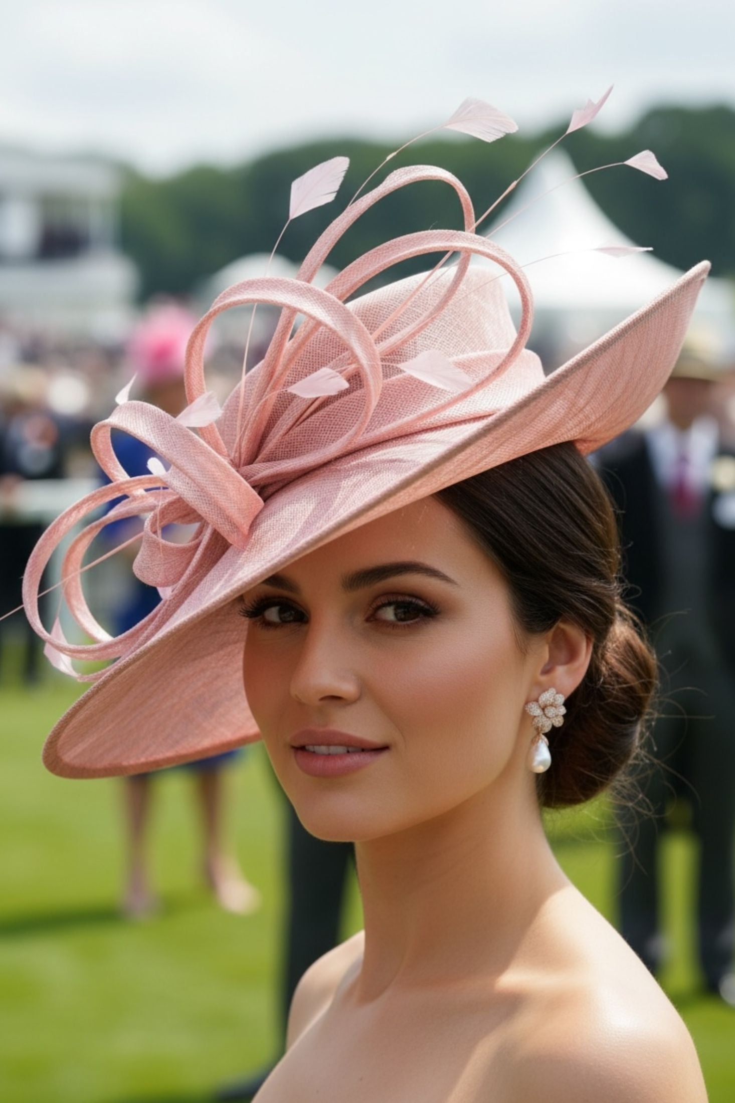 Woman wearing a large pink hat with decorative elements at an outdoor event.