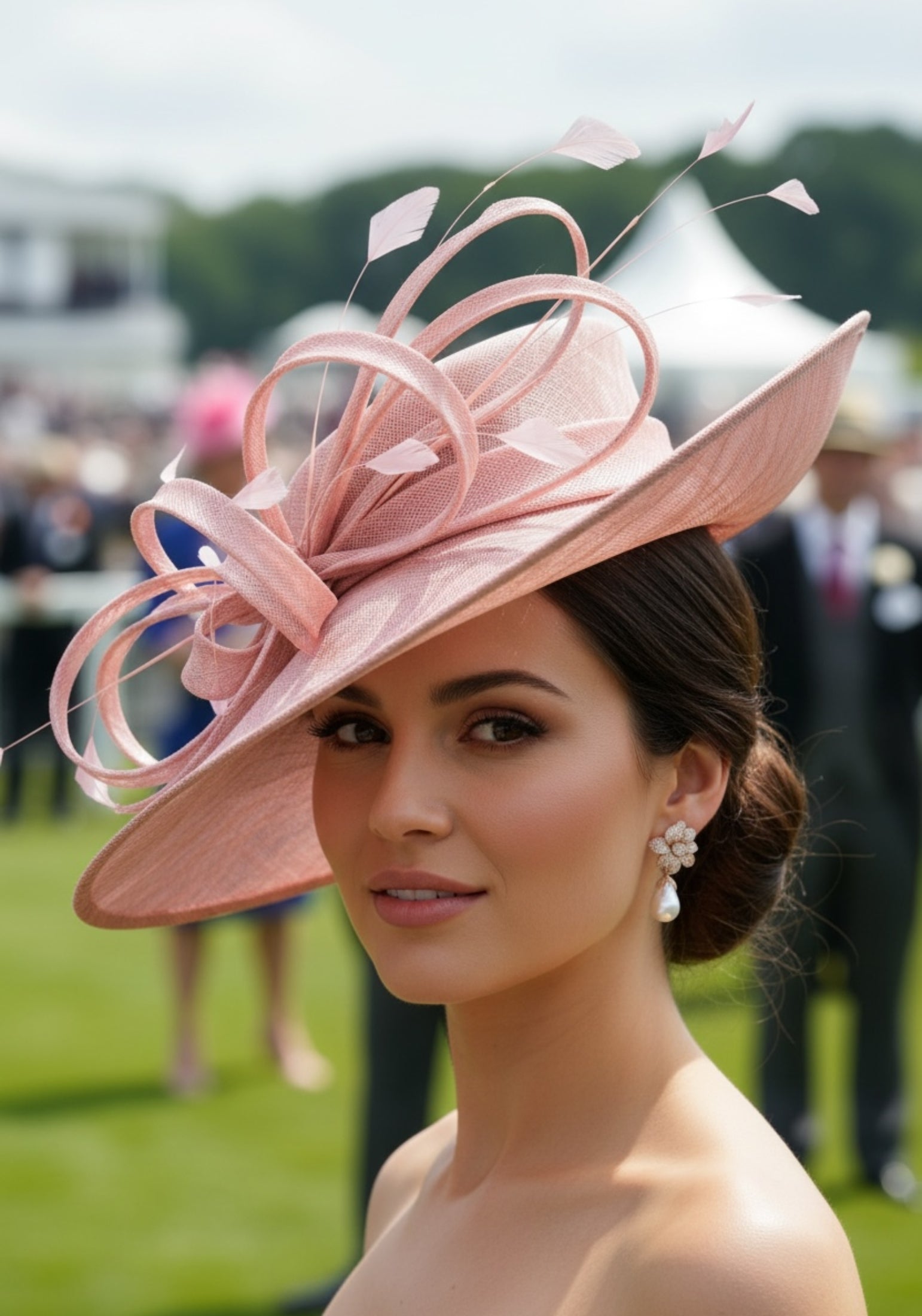 Woman wearing a large pink hat with decorative elements at an outdoor event.