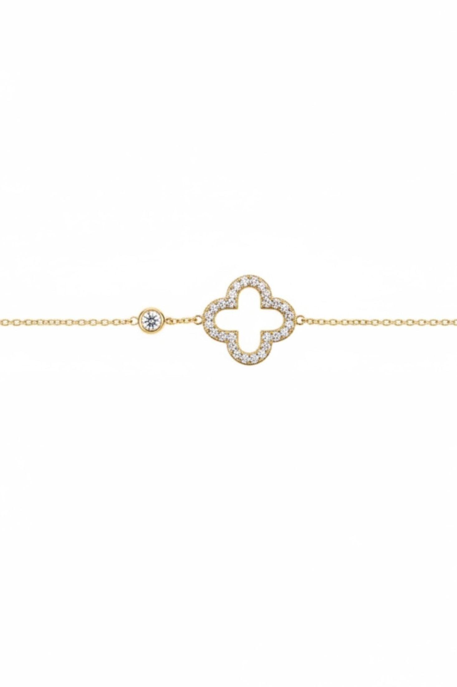 Gold bracelet with a clover-shaped design on a white background