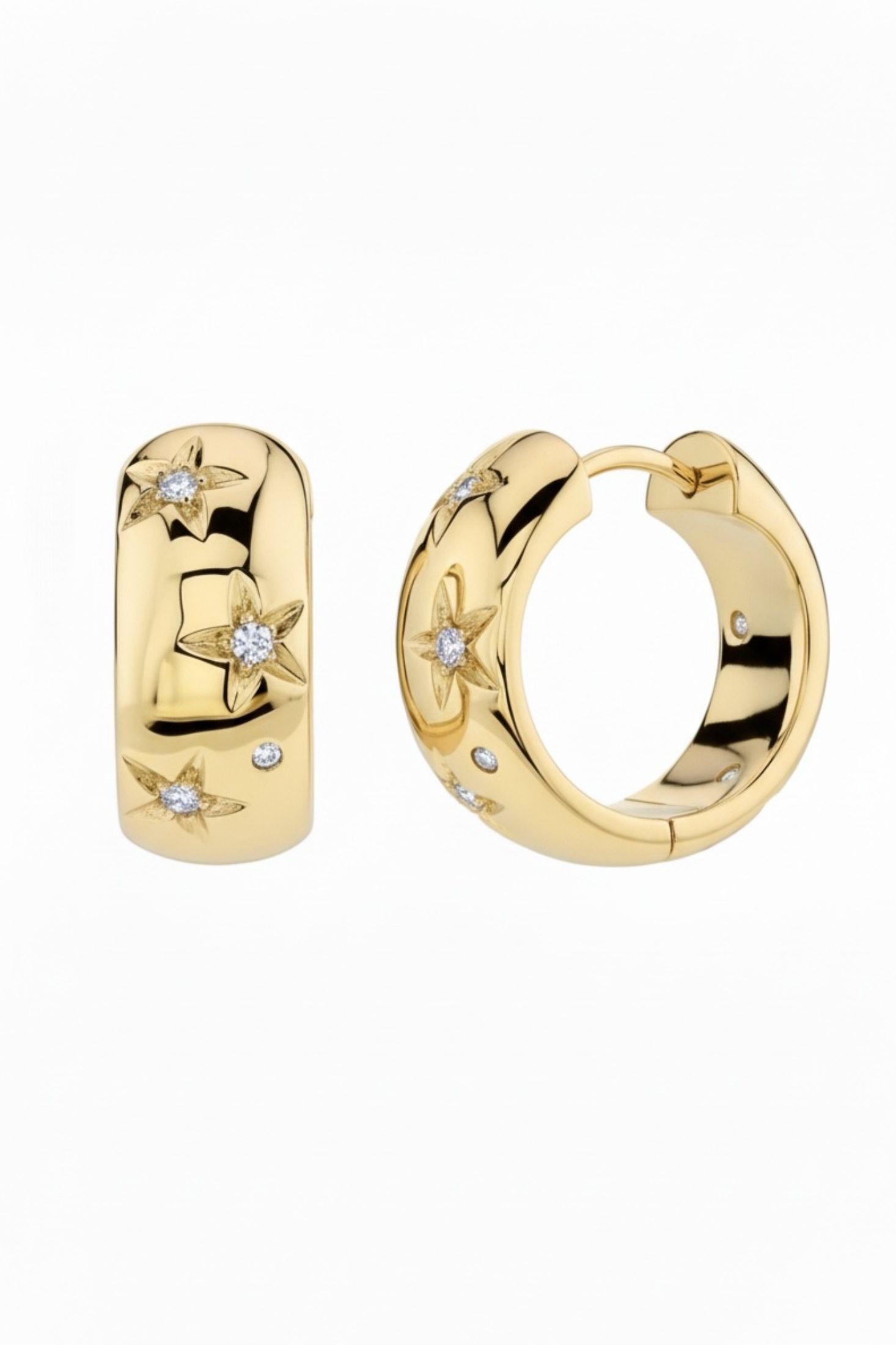 Gold hoop earrings with star designs and small diamonds on a white background
