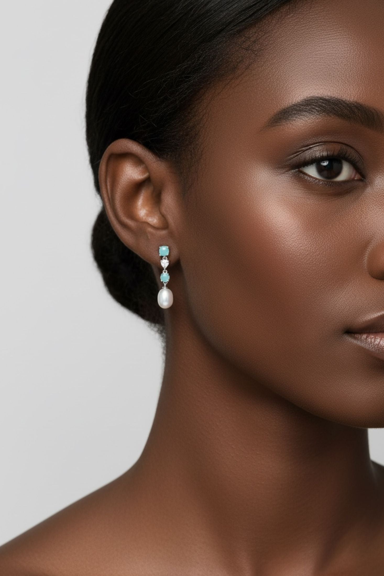 Angled view of Pearl Whisper Drop Earrings Paraiba Tourmaline Silver, showing pearl detailing, silver finish and the jewellery profile.