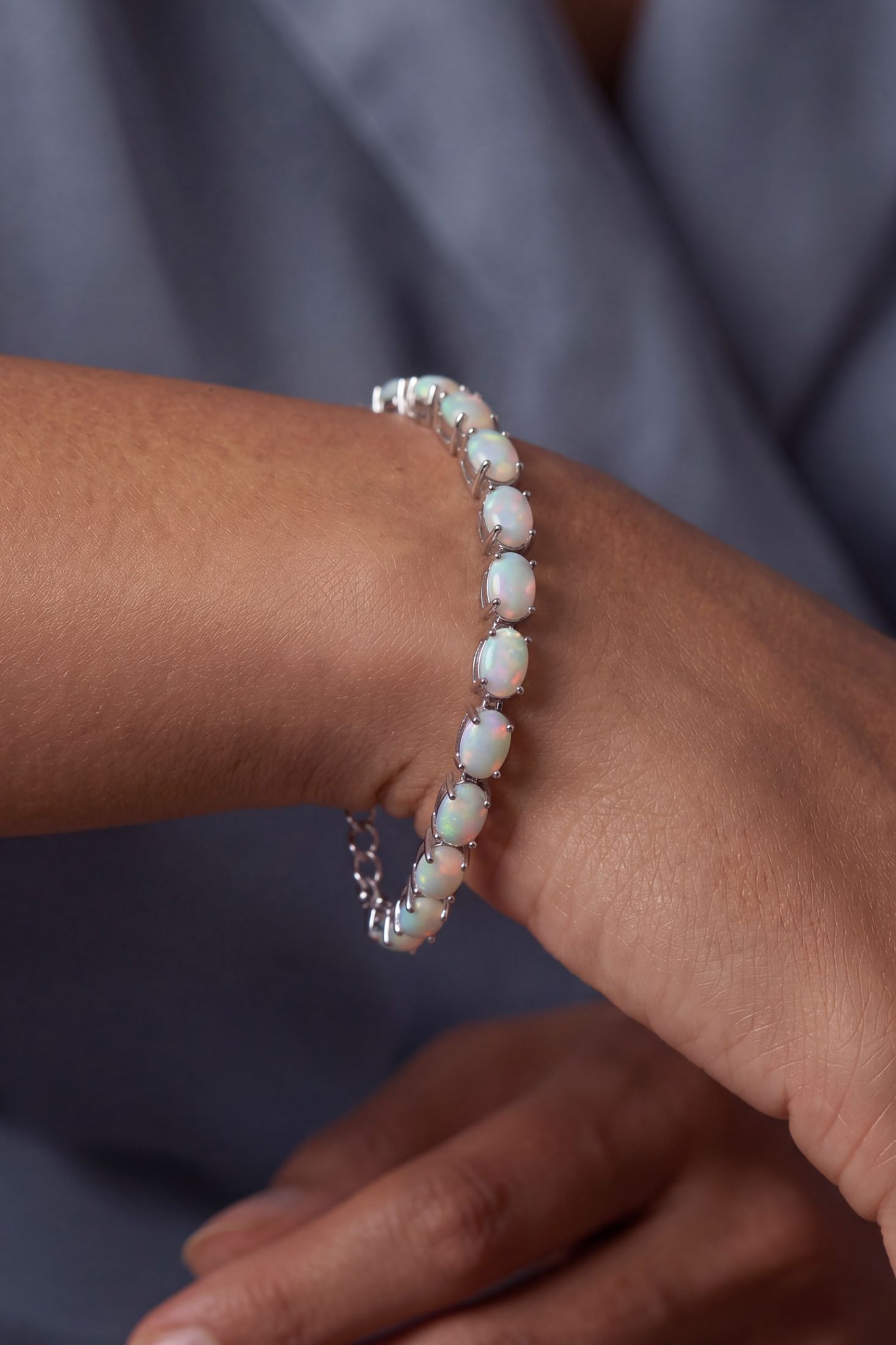 Angled view of White Opal Tennis Bracelet Silver, showing silver finish and the jewellery profile.