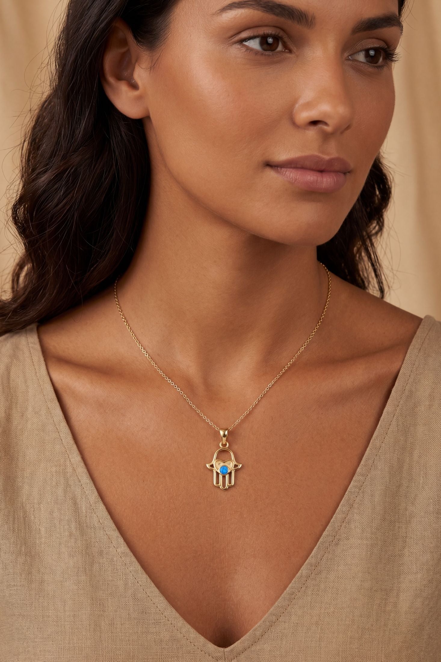 Angled view of Love My Hamsa Hand Blue Opal Pendant Necklace Gold, showing hamsa hand design, gold finish and the jewellery profile.