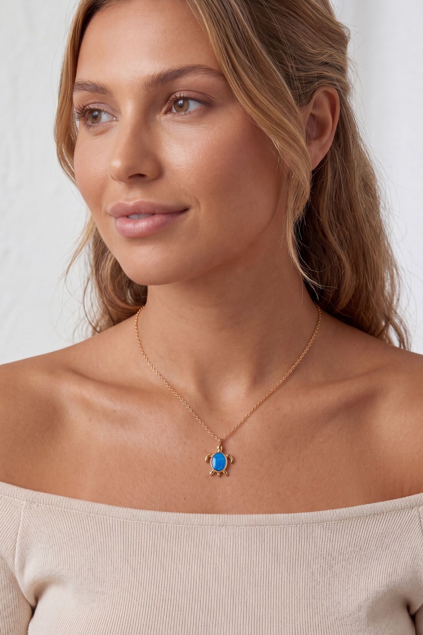 Angled view of Sea Turtle Blue Opal Pendant Necklace Gold, showing turtle design, gold finish and the jewellery profile.