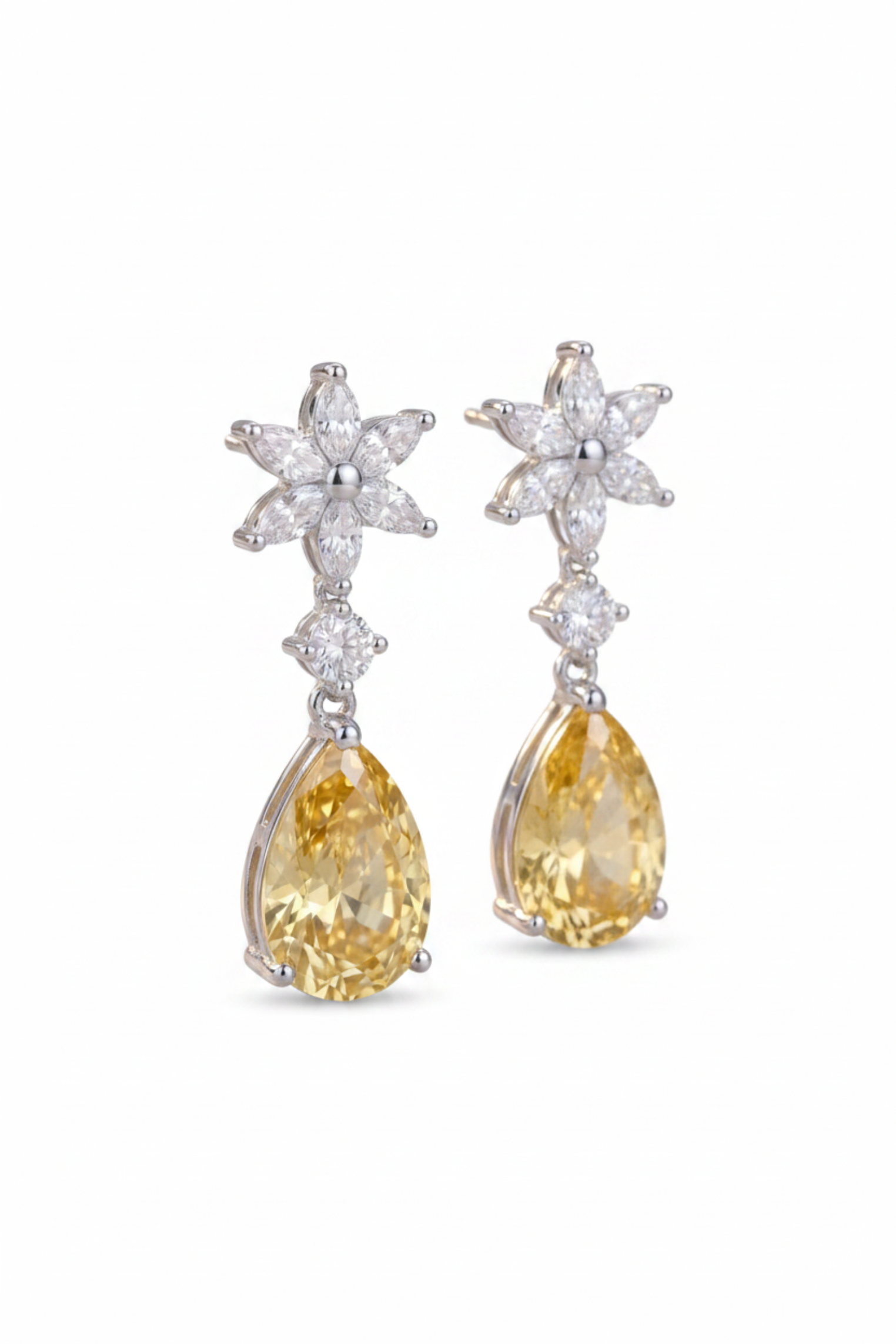 A pair of dangle earrings featuring pear-cut yellow gemstones and starburst-shaped clear stones in a silver-toned setting, shown against a plain white background.
