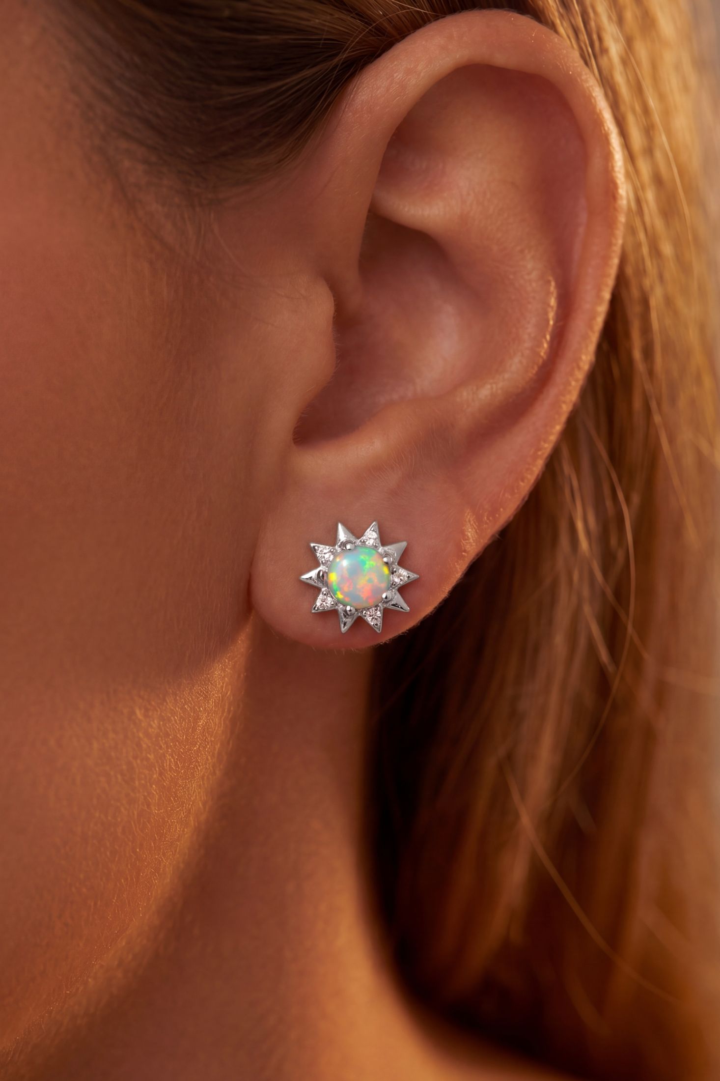 Angled view of Sunflower White Opal Stud Earrings Silver, showing flower design, silver finish and the jewellery profile.