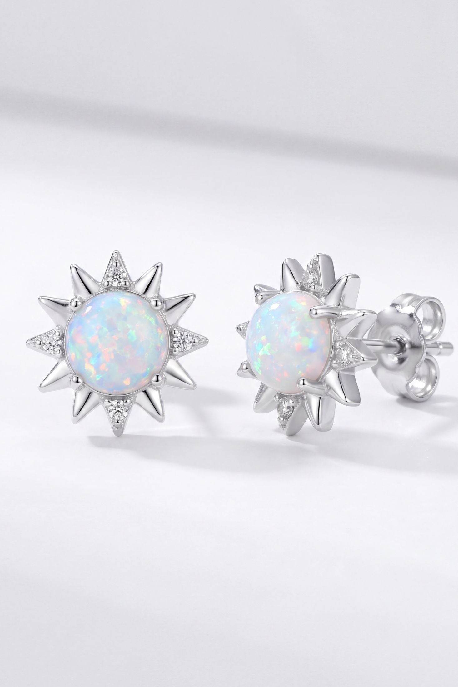 Angled view of Sunflower White Opal Stud Earrings Silver, showing flower design, silver finish and the jewellery profile.