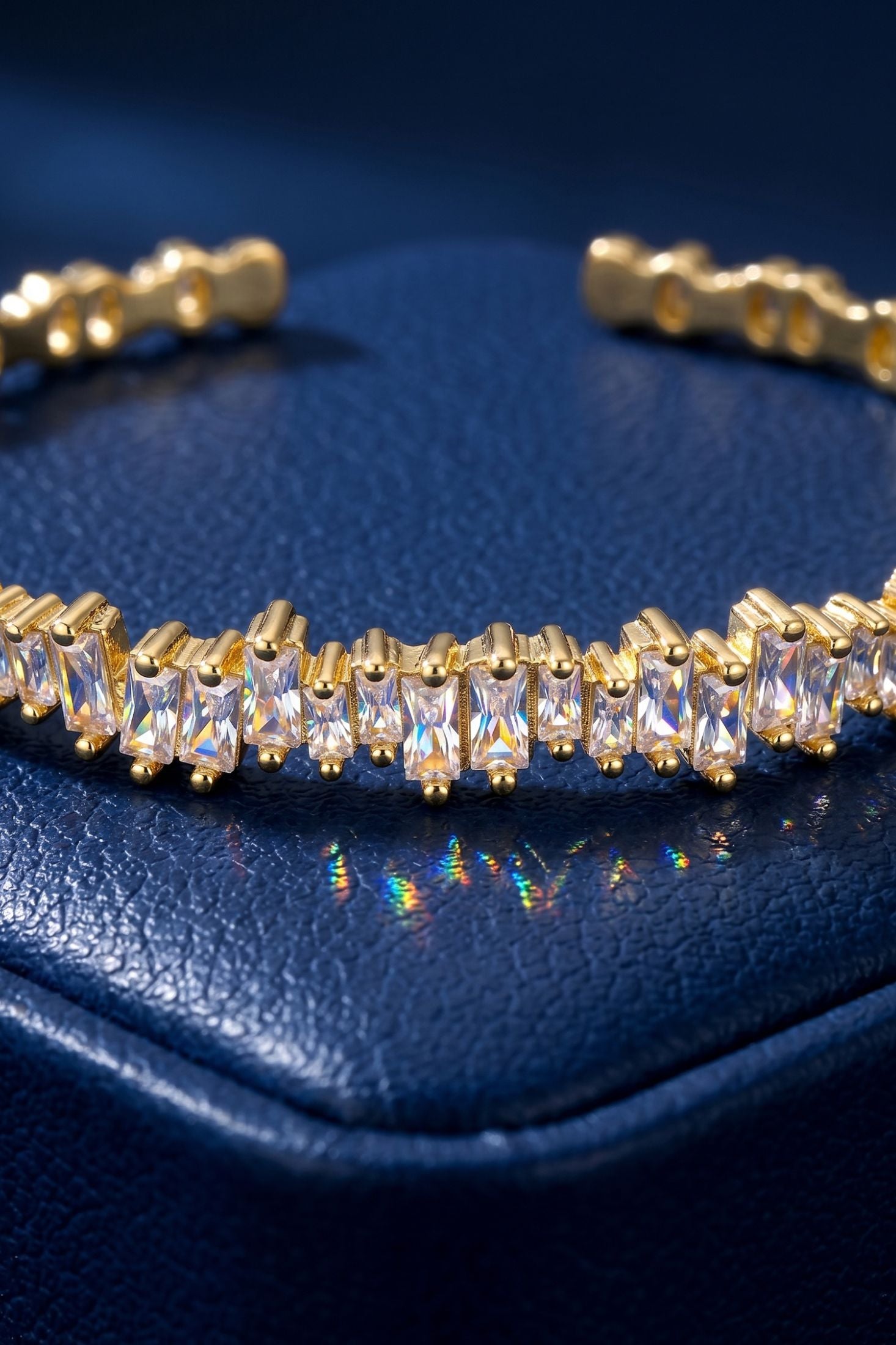 Close-up of Baguette Ice Cuff Bangle Gold White, highlighting gold finish.