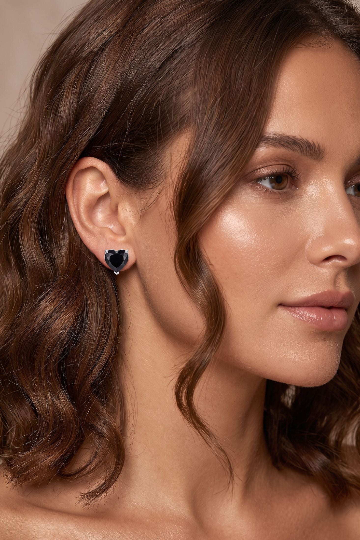 Angled view of Amore Heart Black Spinel Stud Earrings Silver, showing heart design, silver finish and the jewellery profile.