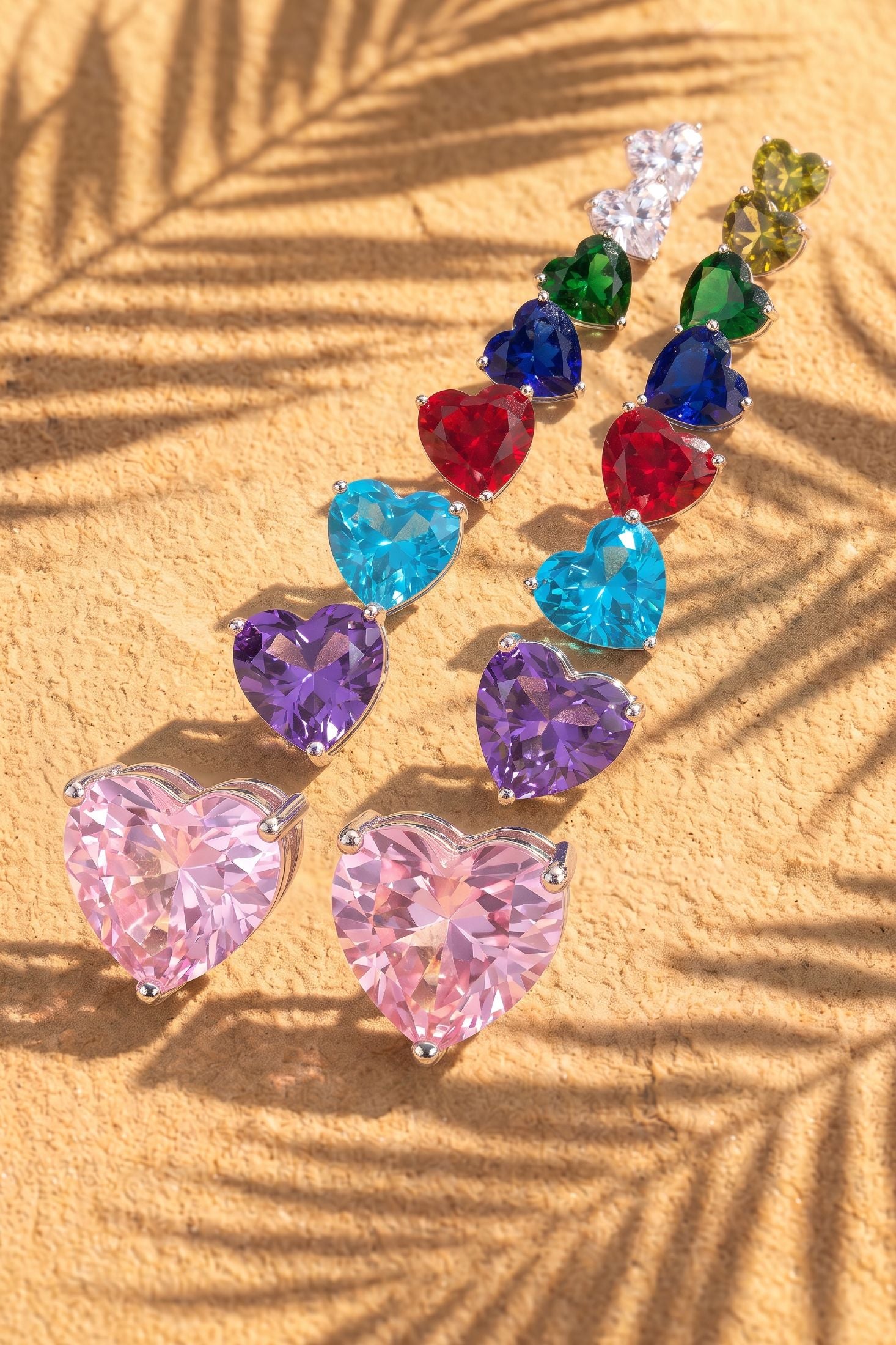 Close-up of Amore Heart Sapphire Stud Earrings Silver, highlighting heart design, sapphire detailing, silver finish.