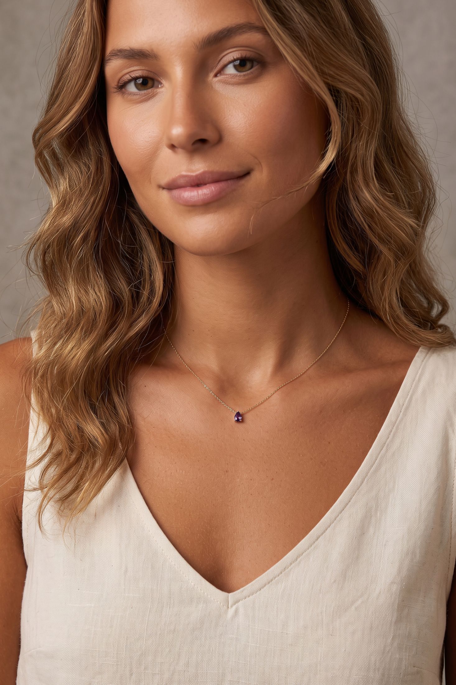 Angled view of Adele Teardrop Necklace Gold Amethyst, showing amethyst detailing, gold finish and the jewellery profile.