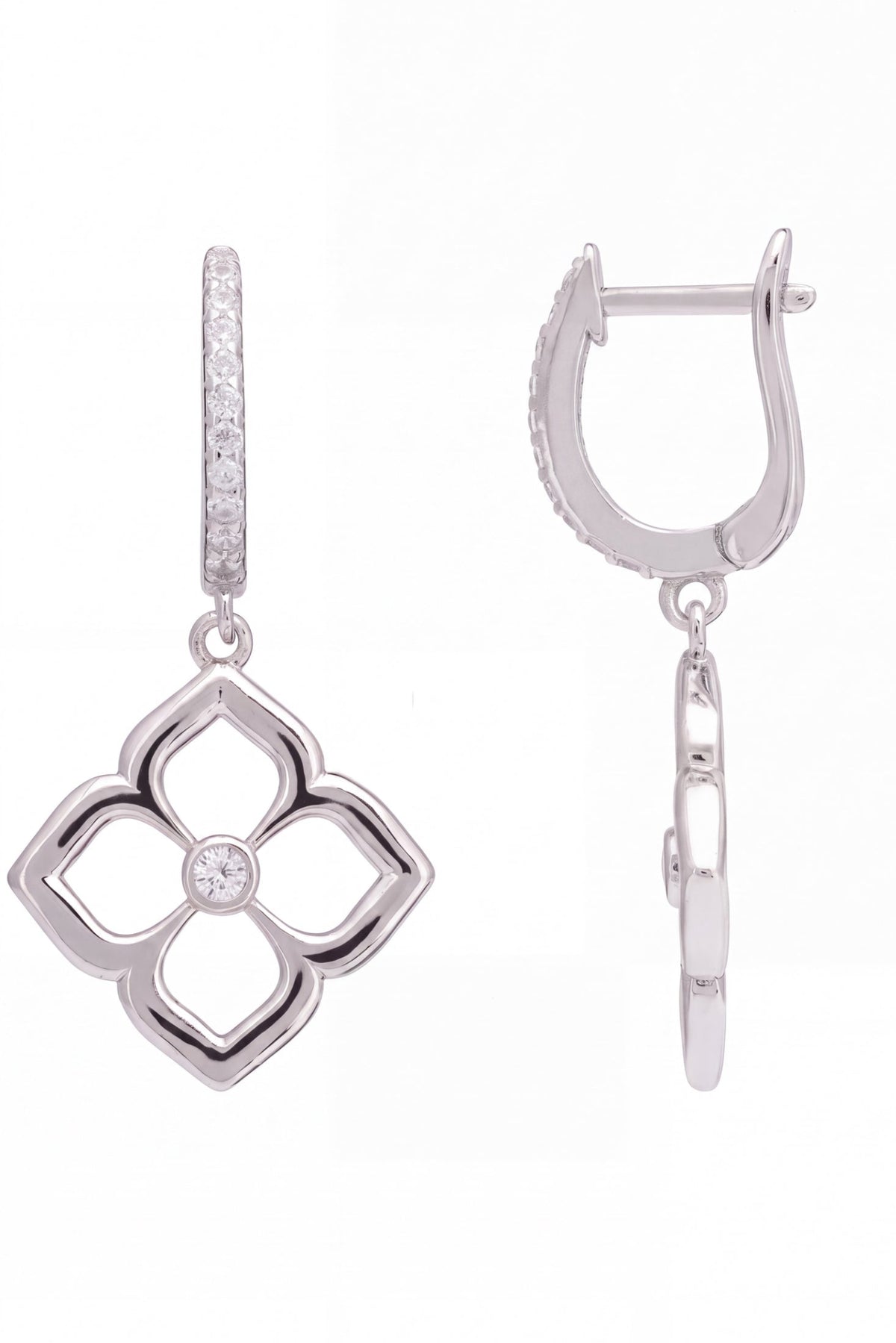 A pair of silver-toned drop earrings on a white background, showing both the front view of a four-leaf clover pendant with a central clear stone and the side profile of the huggie hoop with a vertical row of small clear stones.