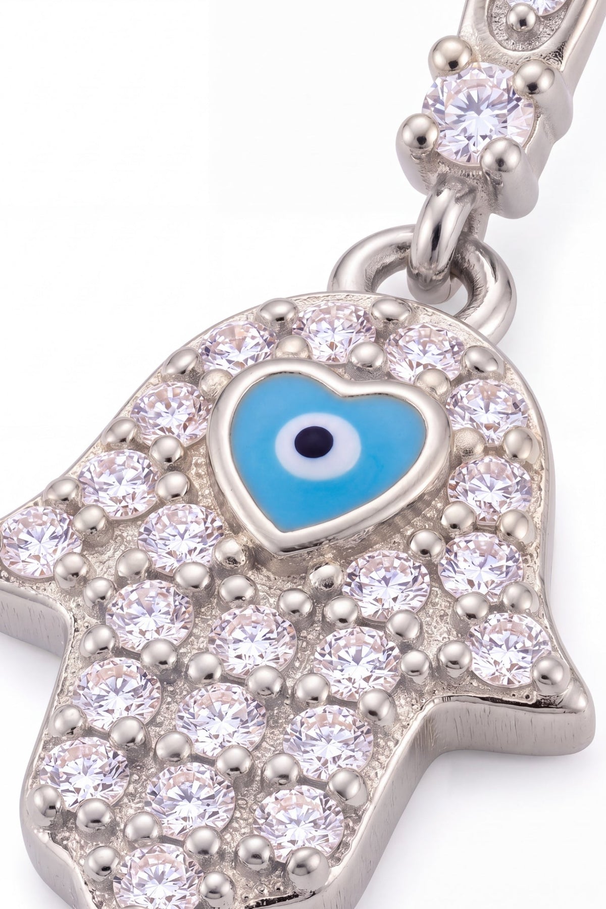 Silver Hamsa hand pendant with sparkling crystals and a blue evil eye heart center.