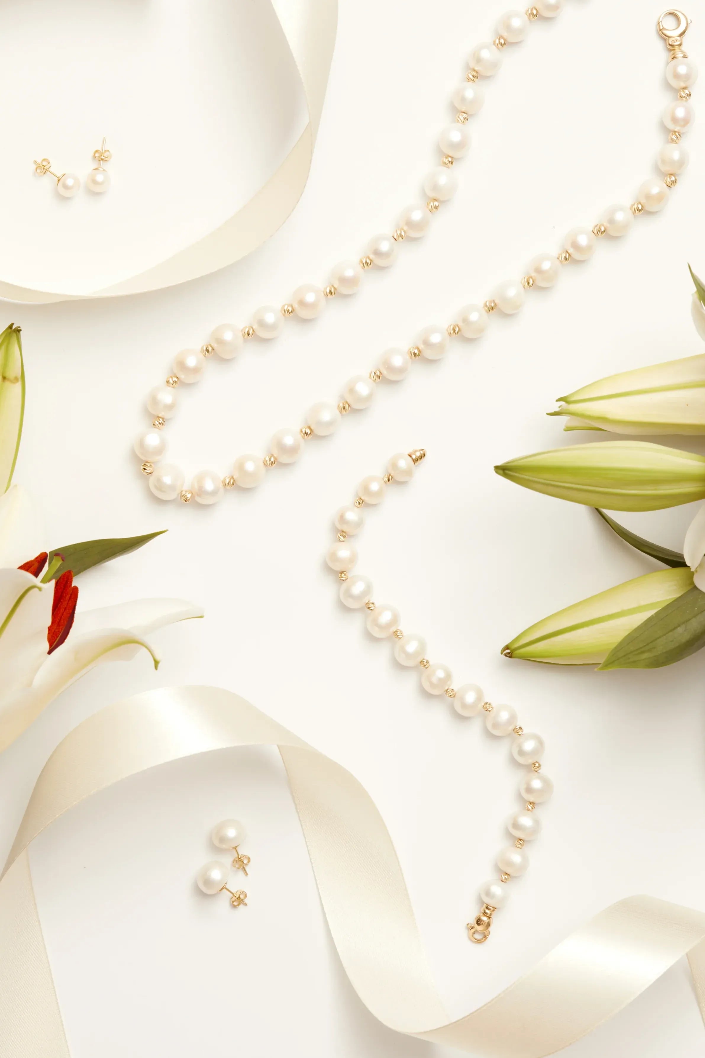 Close-up of Solid 14K Gold 8mm Classic Natural Pearl Stud Earrings, highlighting pearl detailing, gold finish.