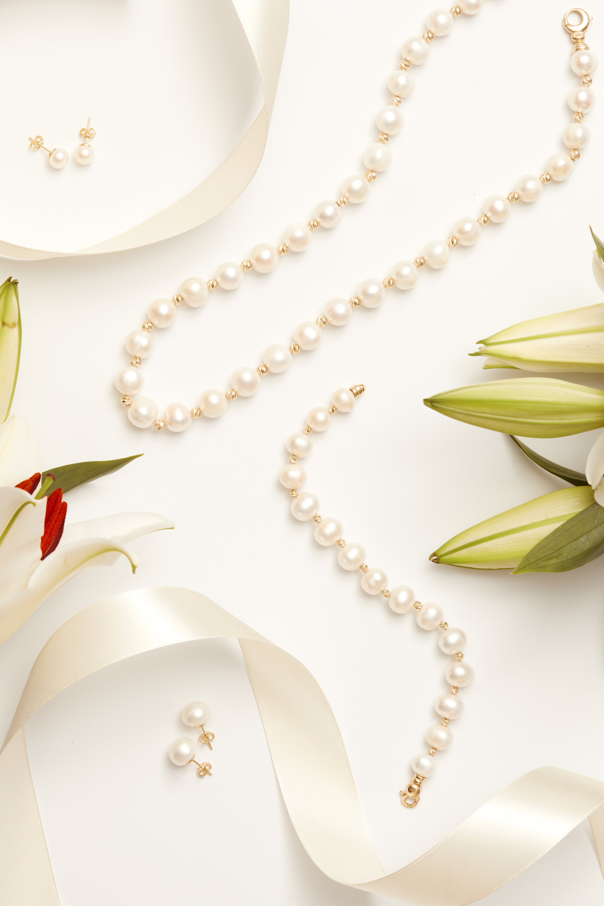 Close-up of Solid 14K Gold 11mm Classic Natural Pearl Stud Earrings, highlighting pearl detailing, gold finish.