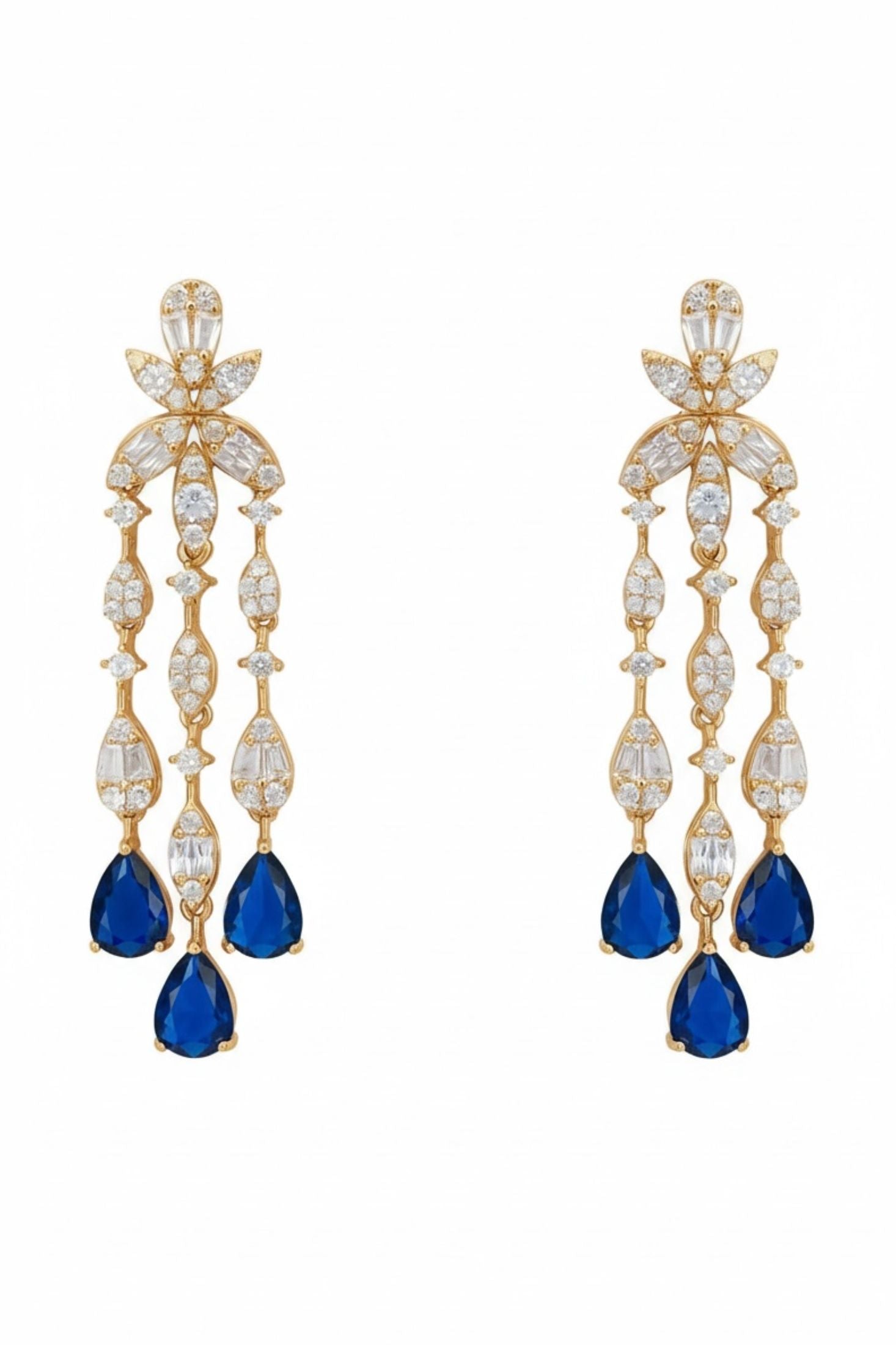 Pair of gold earrings with blue teardrop stones on a white background