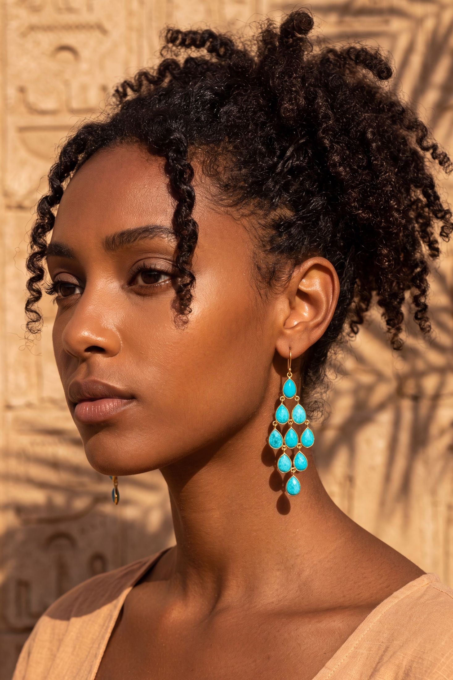 Angled view of Erviola Gemstone Cascade Earrings Silver Turquoise, showing turquoise detailing, silver finish and the jewellery profile.