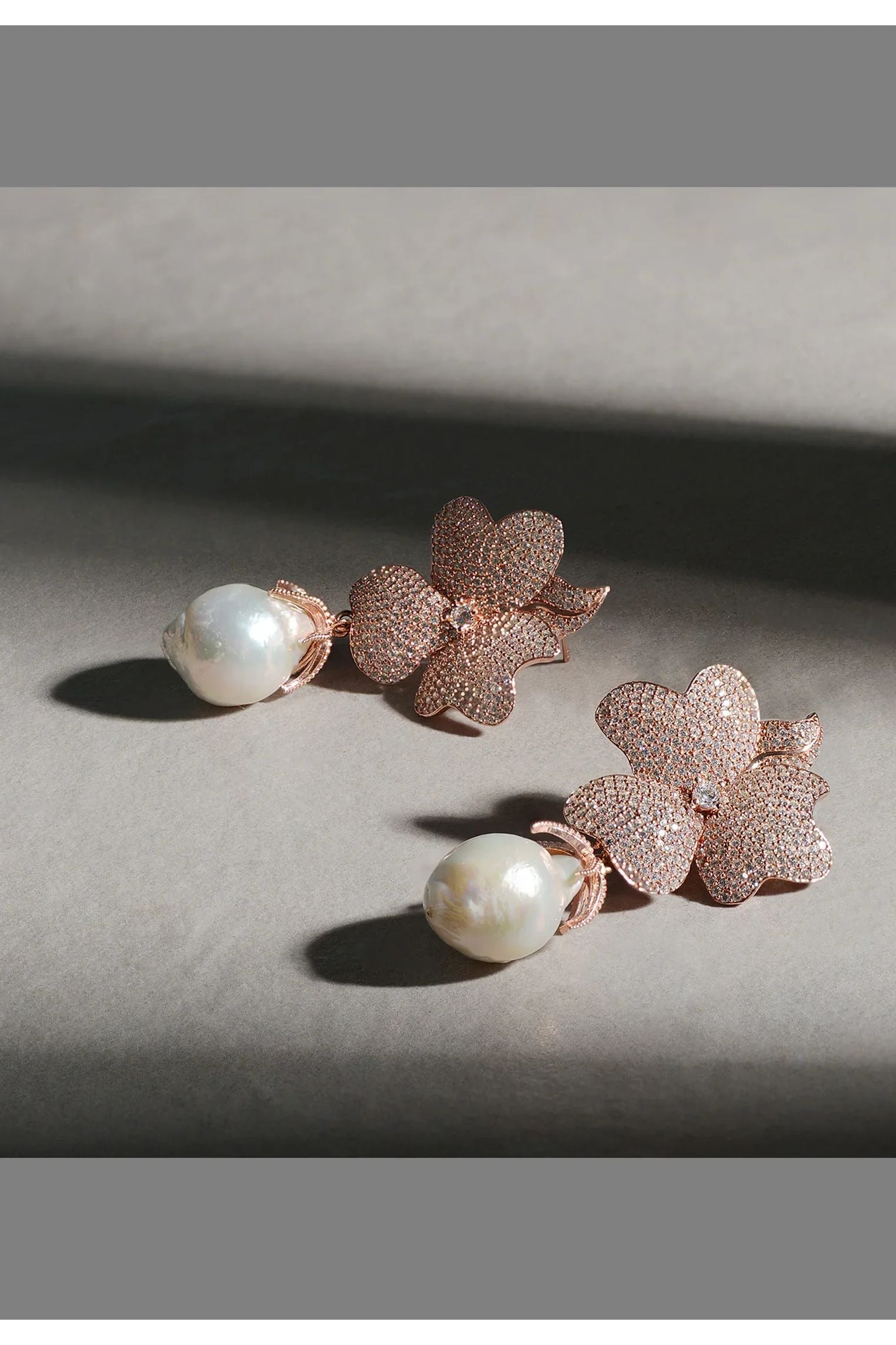 Pearl and rose gold flower earrings.