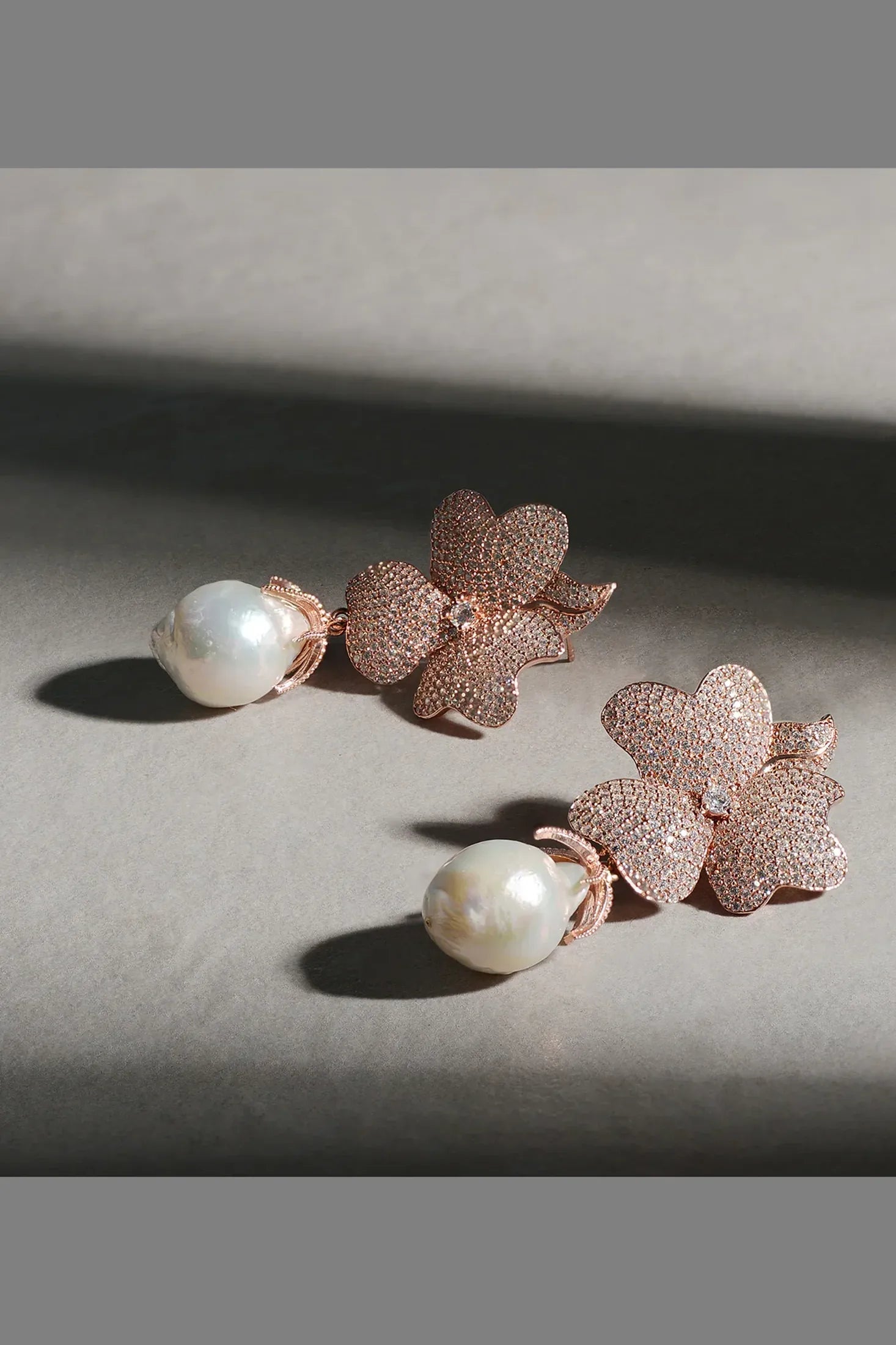Pearl and rose gold flower earrings.