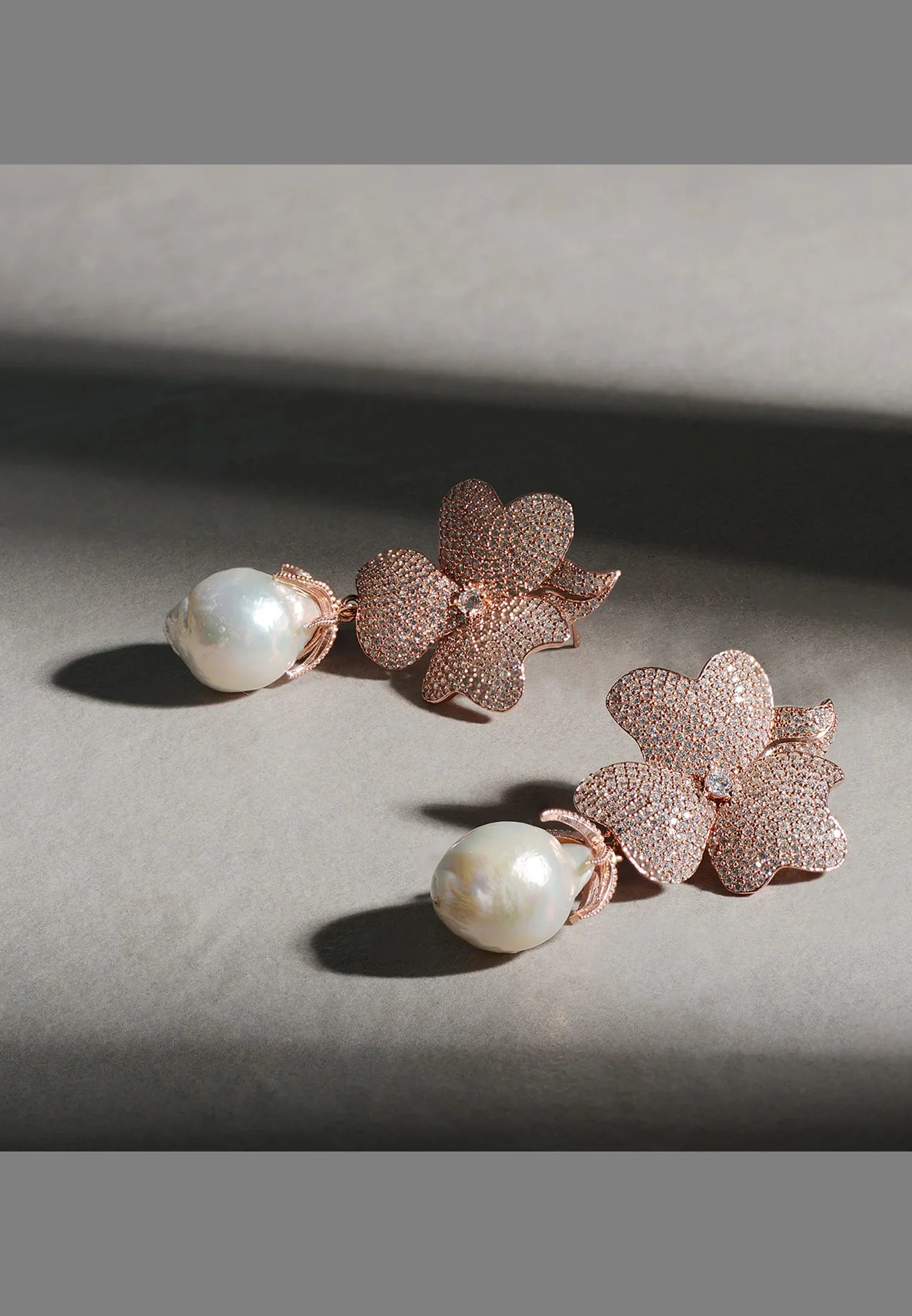 Pearl and rose gold flower earrings.