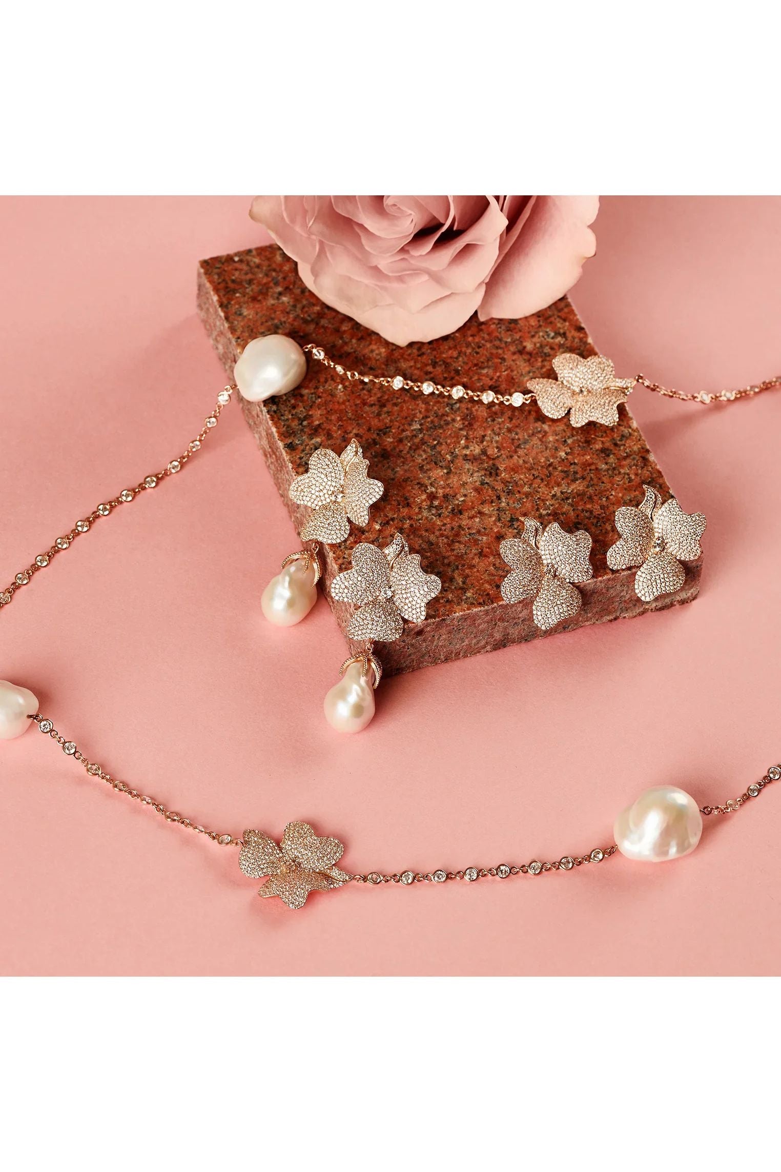 Large rose gold flower earrings with and without pearls, alongside a matching necklace with pearls.