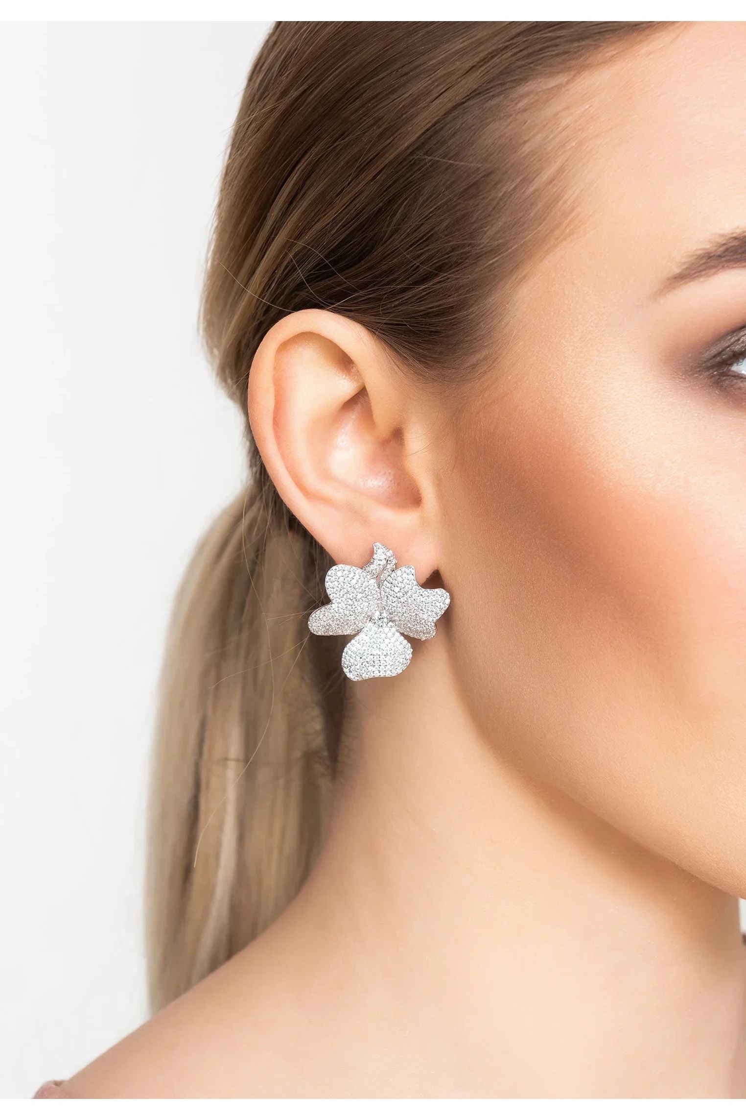 The earring worn by a model.