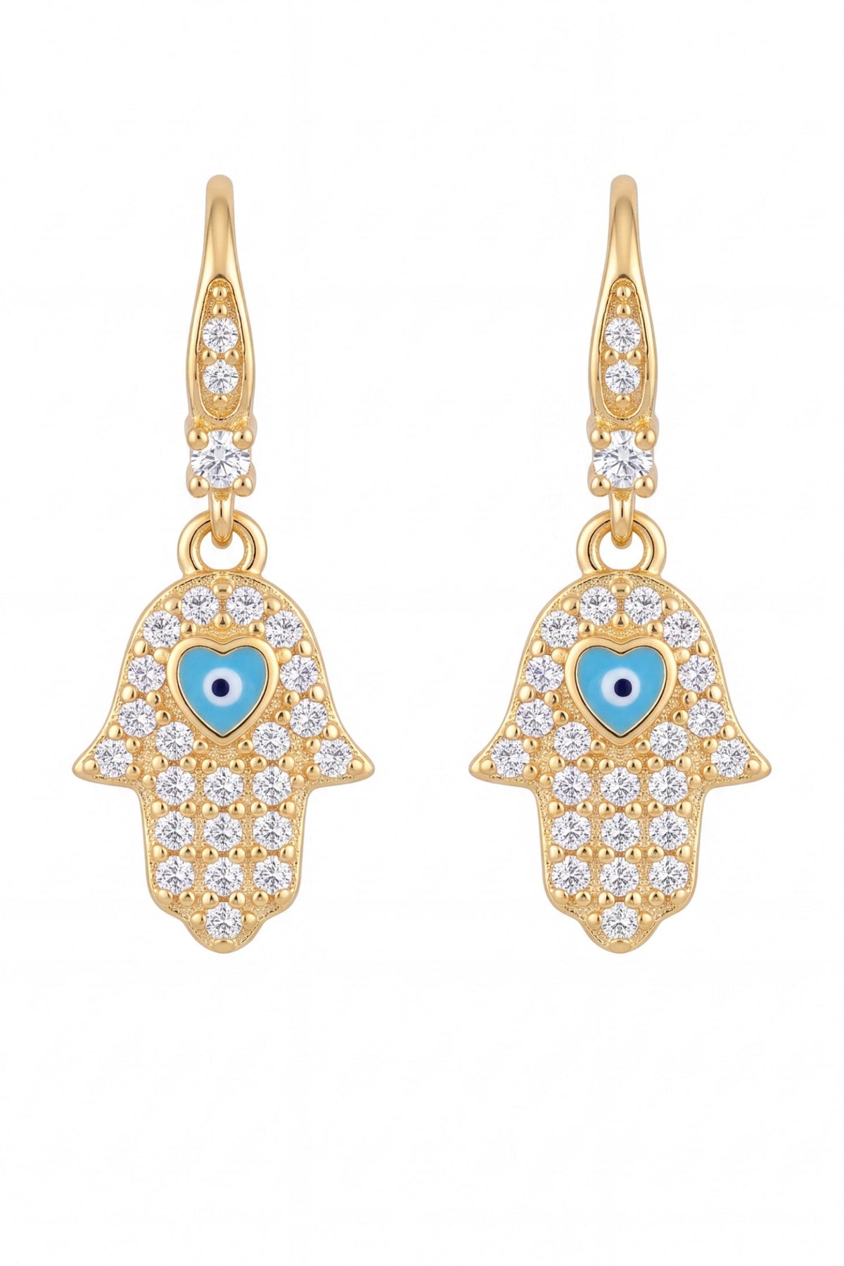 A pair of gold Hamsa hand drop earrings adorned with clear crystals and a central light blue enamel heart with a black and white eye detail, set against a plain white background.