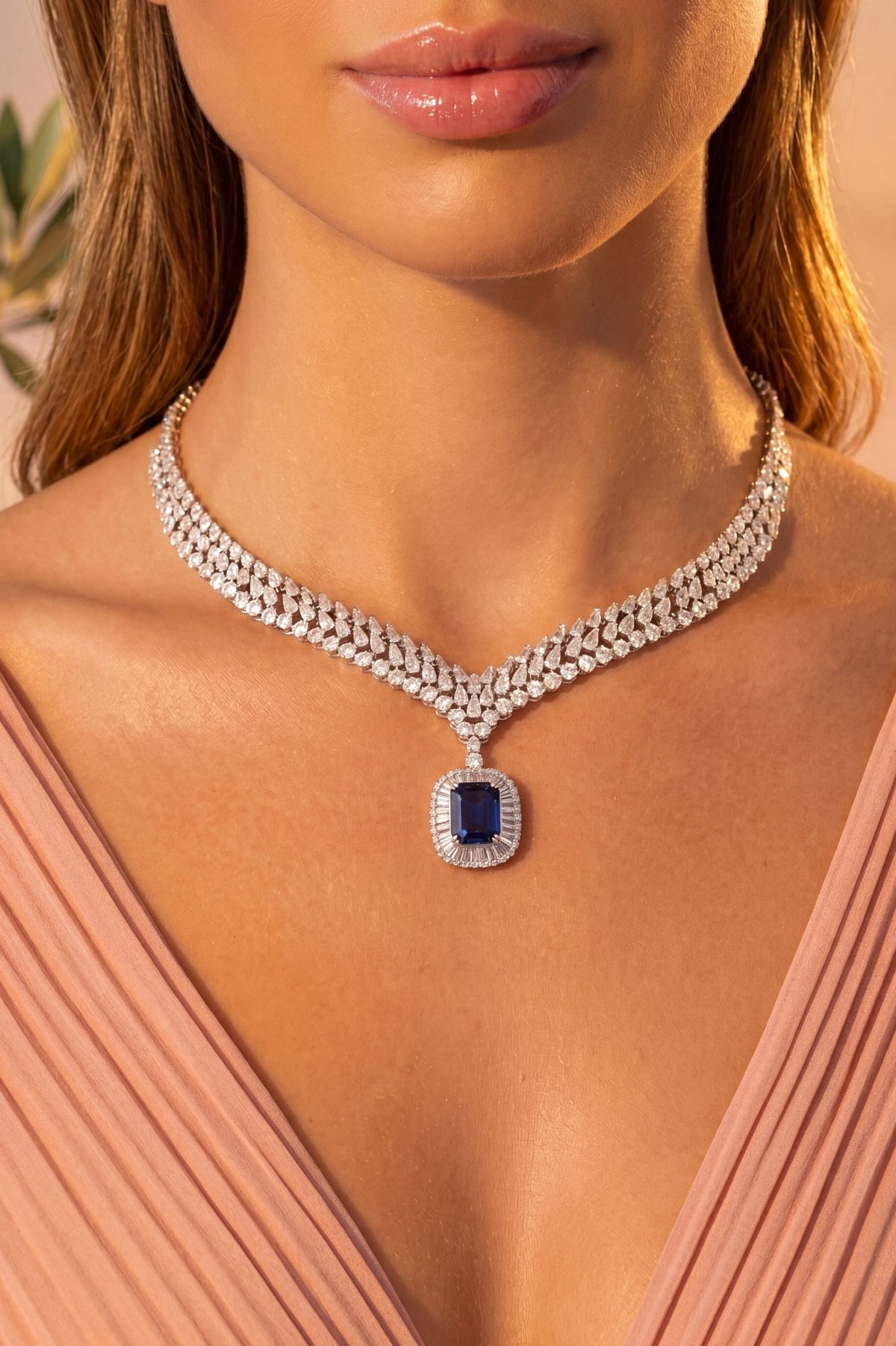 Angled view of Countess Statement Sapphire Necklace Silver, showing sapphire detailing, silver finish and the jewellery profile.