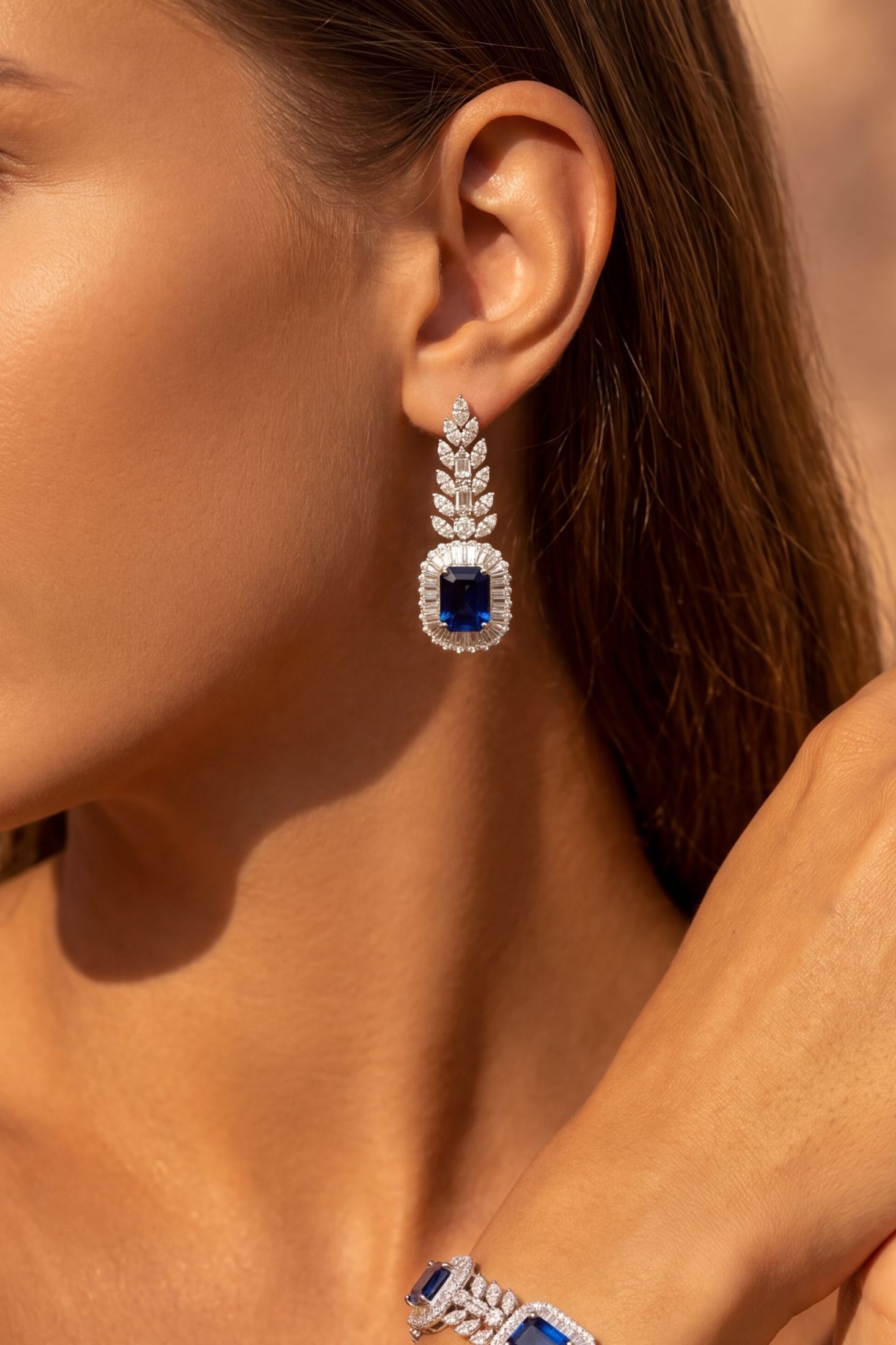 Angled view of Countess Gemstone Drop Earrings Sapphire Silver, showing sapphire detailing, silver finish and the jewellery profile.