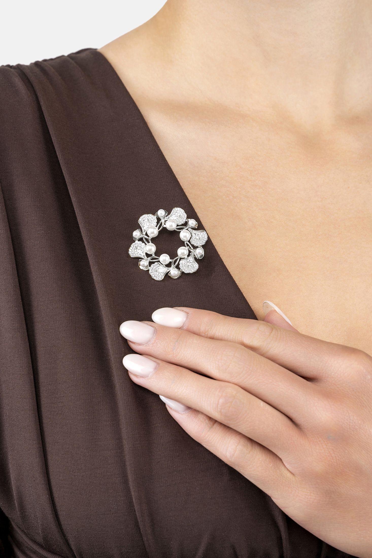 Angled view of Ginkgo Leaf And Pearl Wreath Brooch Silver, showing leaf design, pearl detailing, silver finish and the jewellery profile.