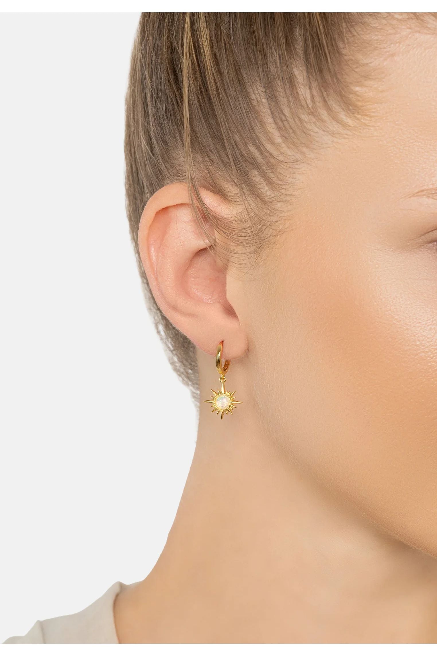 The earring worn by a model.