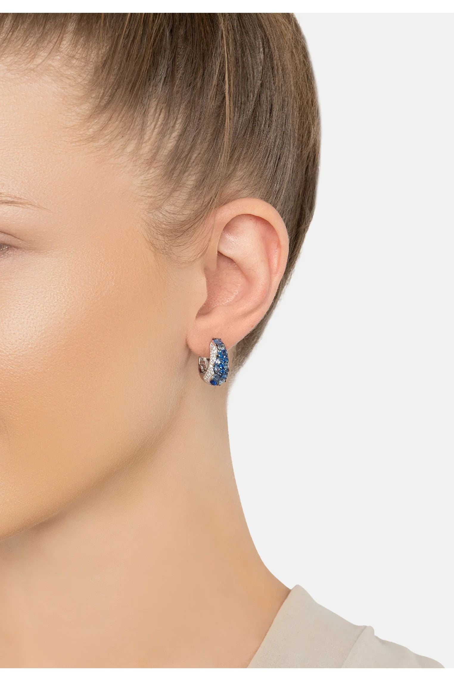 The earring worn by a model.