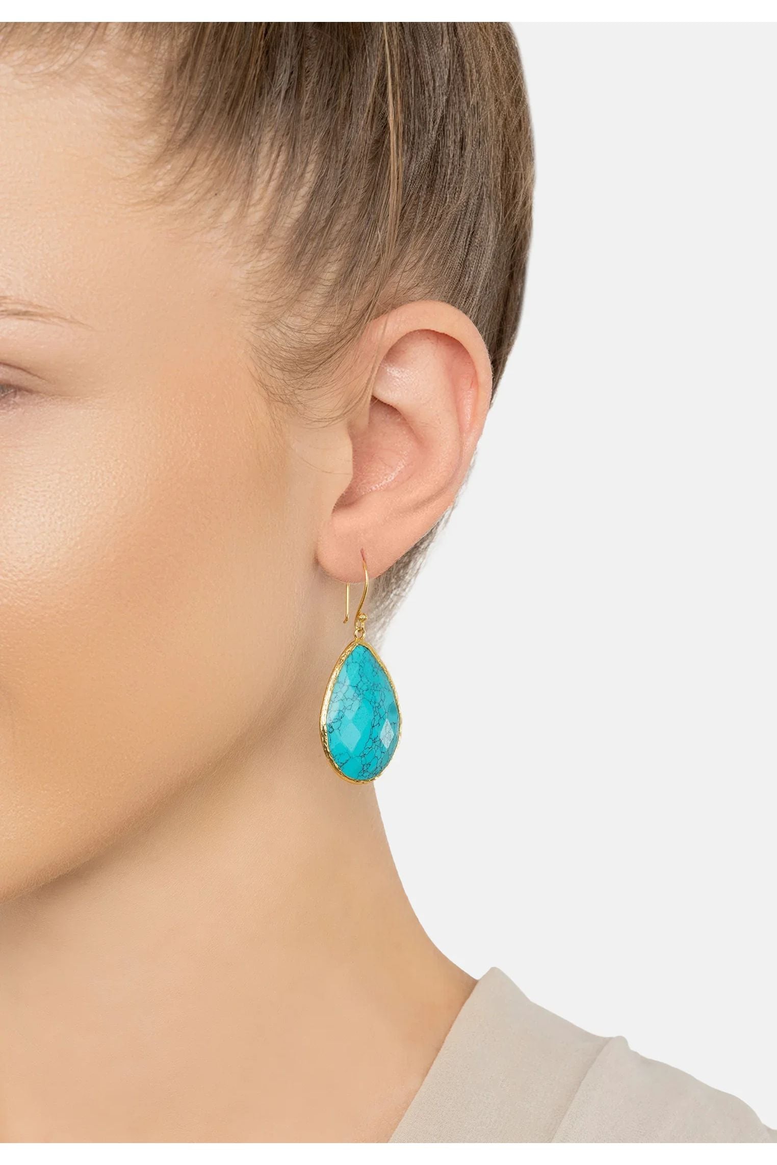 The earring worn by a model.