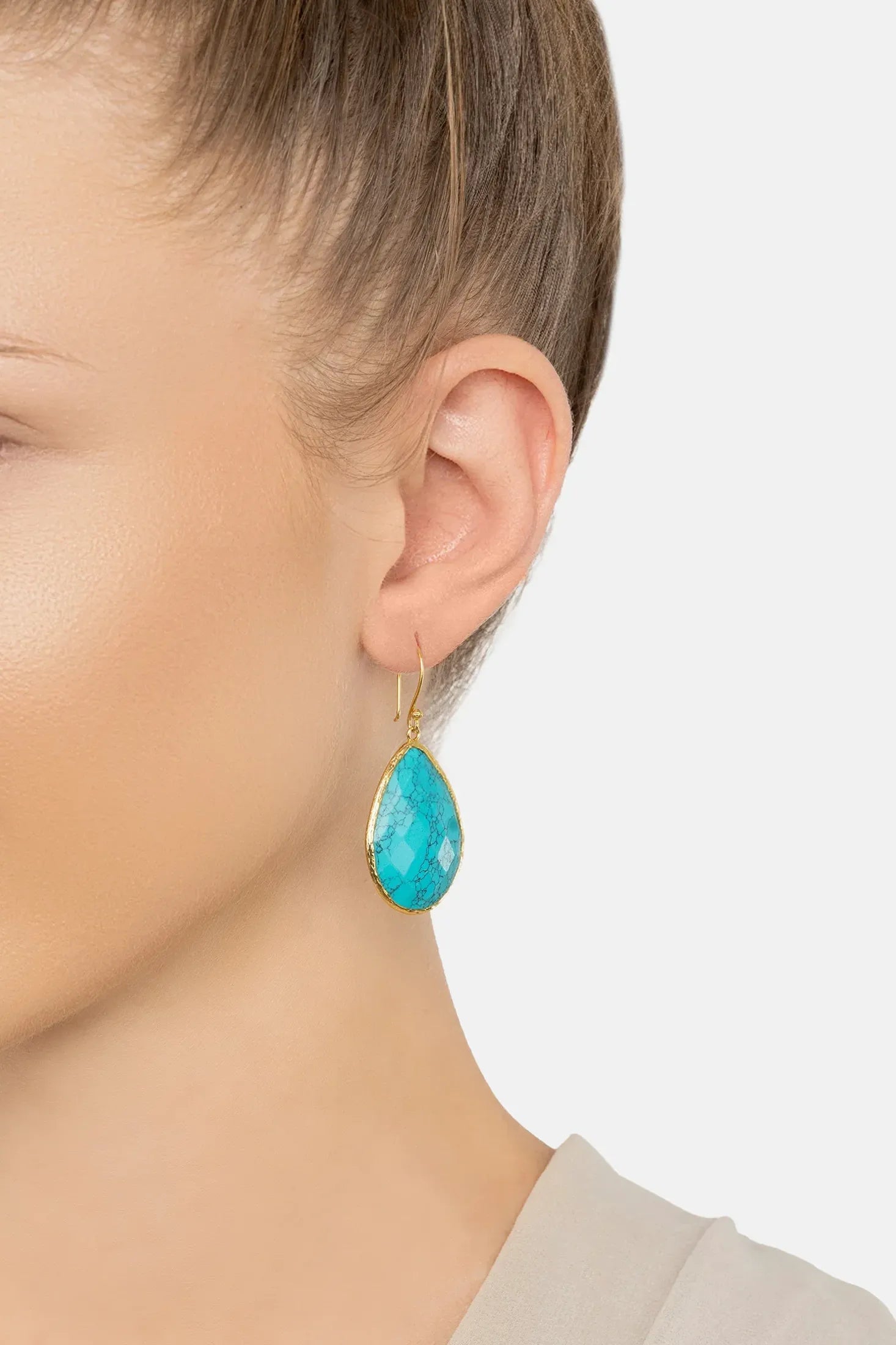 The earring worn by a model.