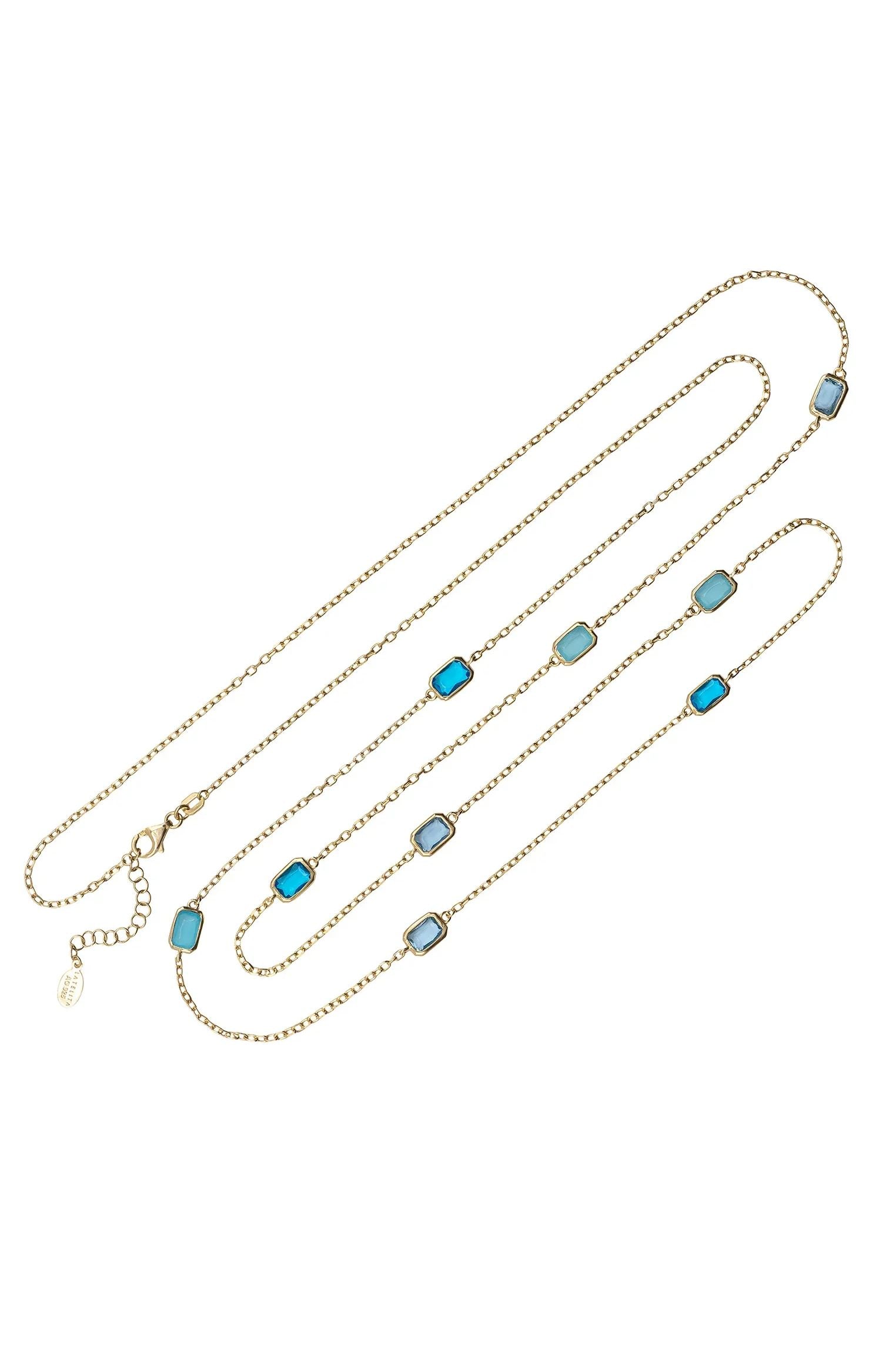 Multiple blue gemstone long gold necklace.