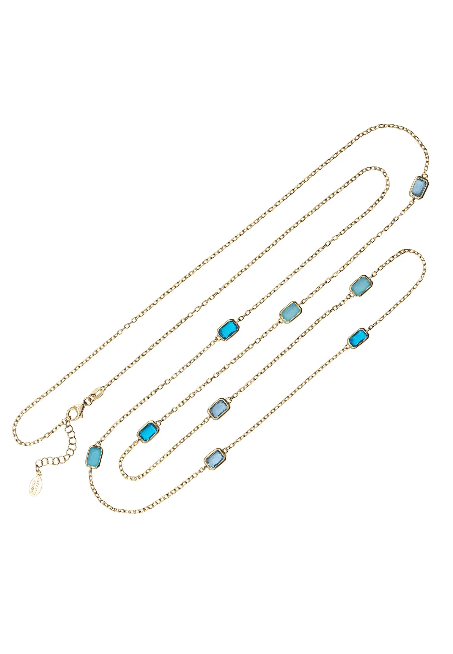 Multiple blue gemstone long gold necklace.