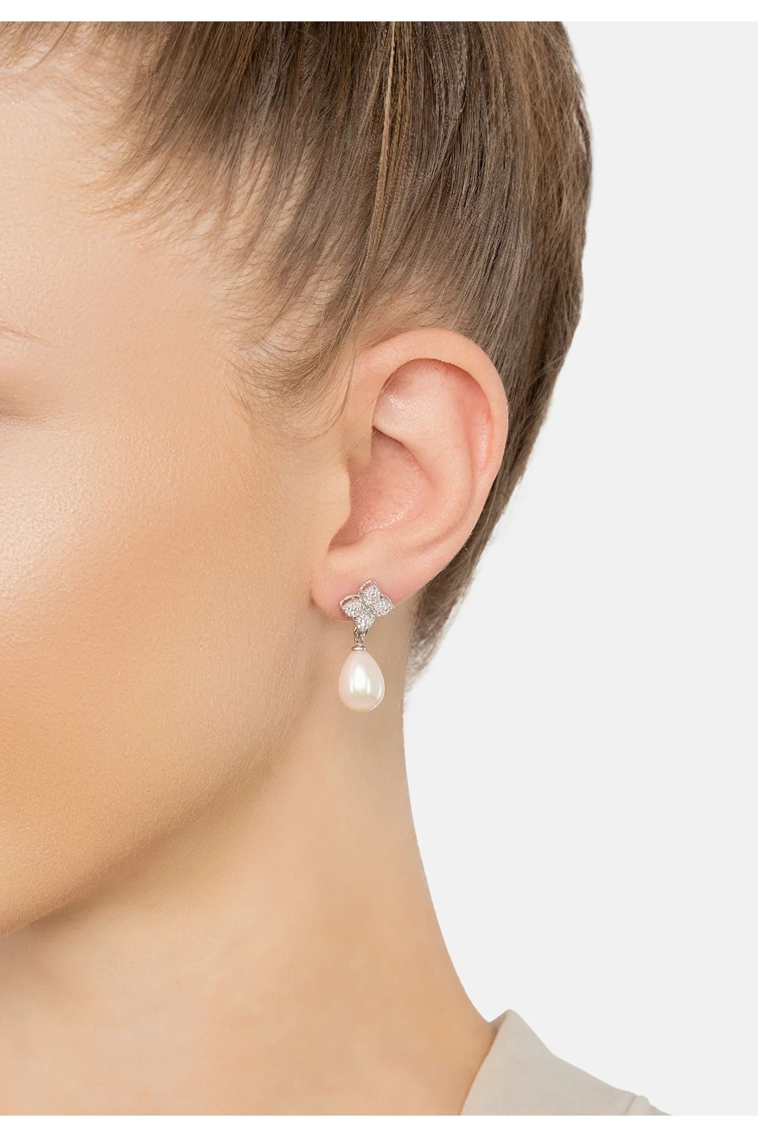 The earring worn by a model.