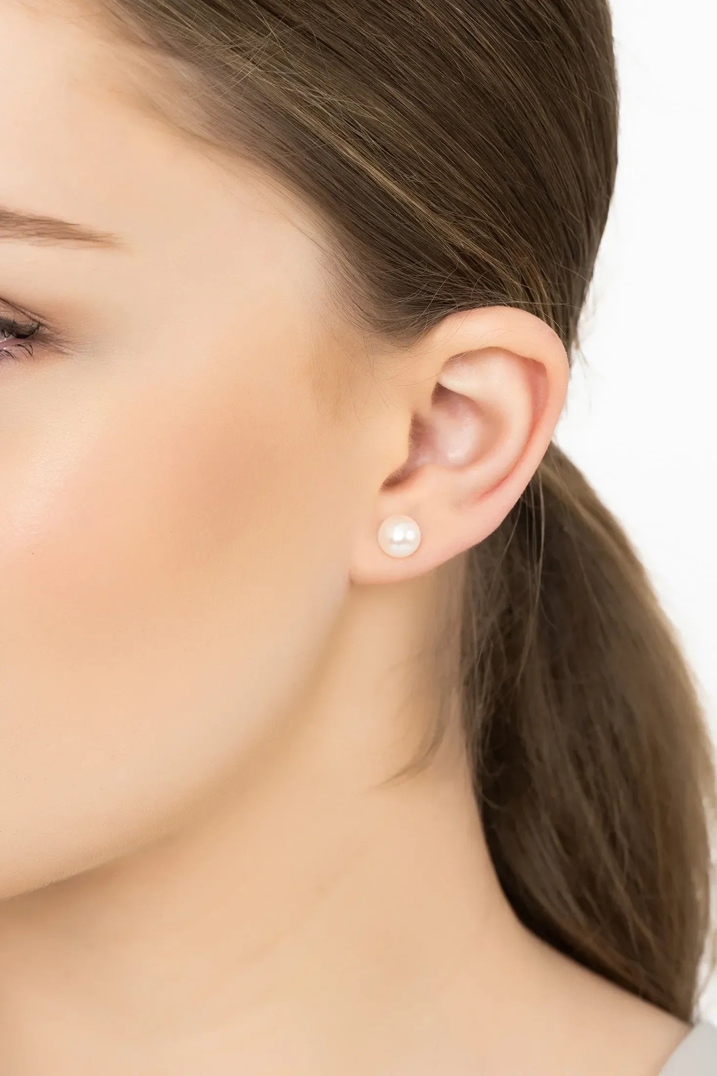 Angled view of Solid 14K Gold 8mm Classic Natural Pearl Stud Earrings, showing pearl detailing, gold finish and the jewellery profile.
