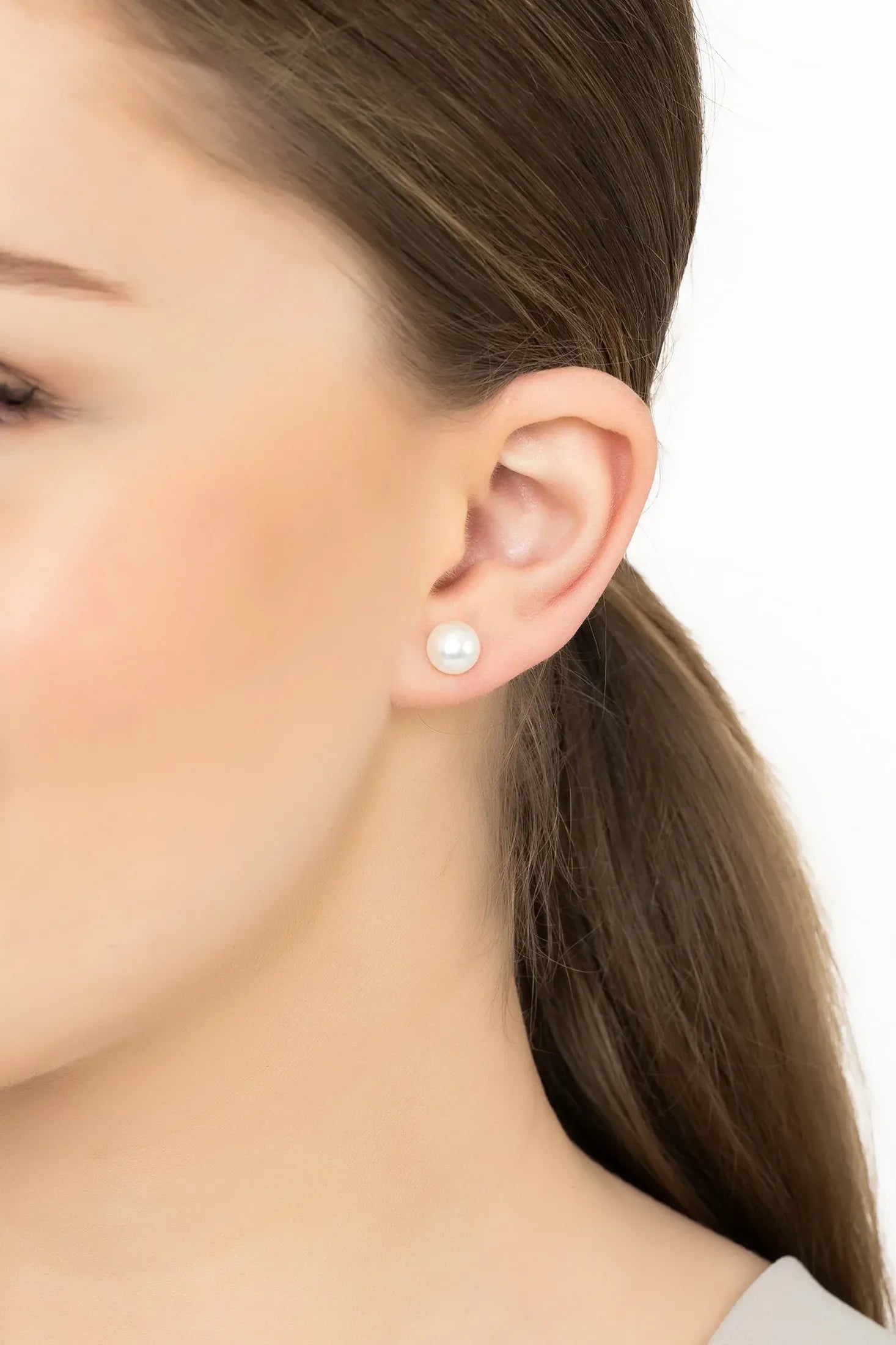 Angled view of Solid 14K White Gold 8mm Classic Natural Pearl Stud Earrings, showing pearl detailing, gold finish and the jewellery profile.