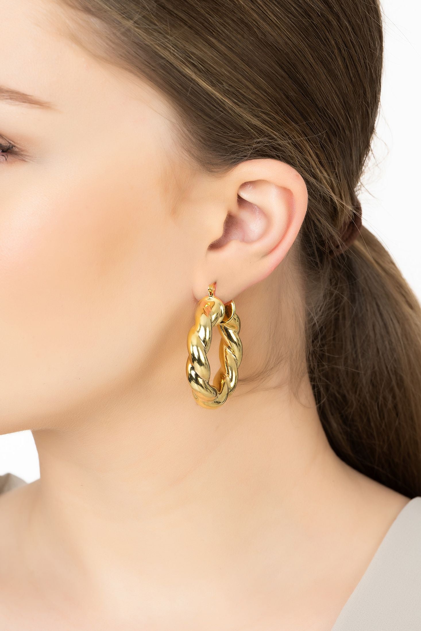 Angled view of Vintage Creole Hoop Earrings Gold, showing gold finish and the jewellery profile.